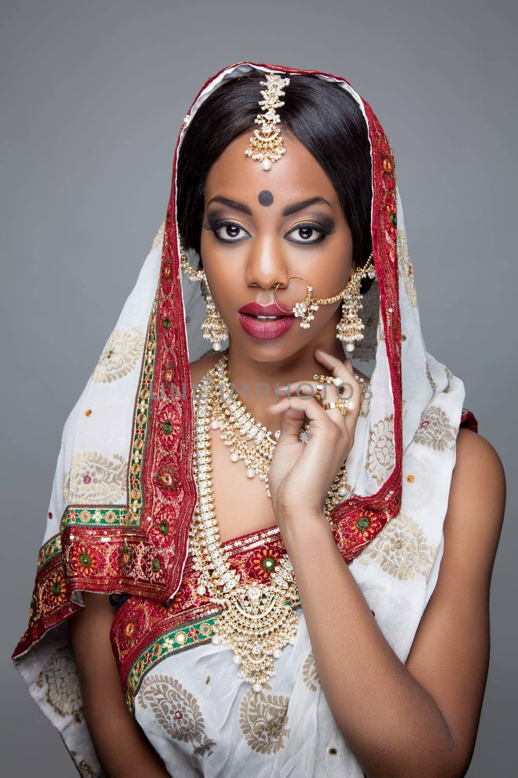 Young Indian woman dressed in traditional clothing with bridal makeup and jewelry