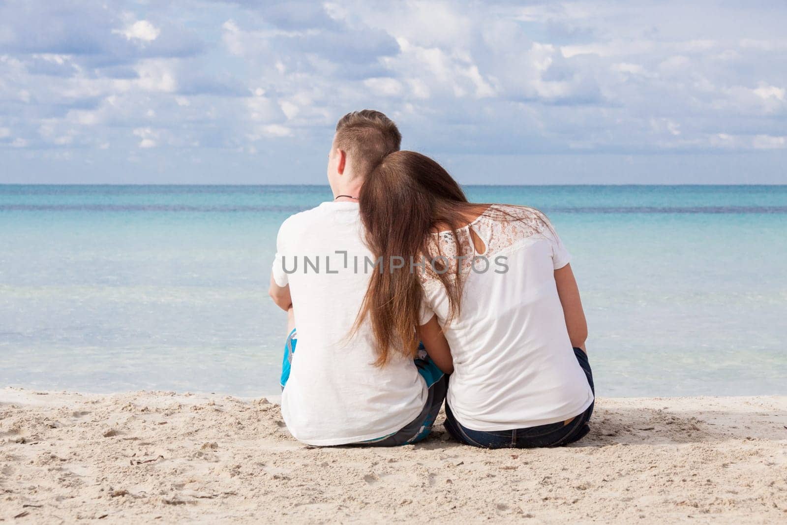 In love young couple on the beach in summer holiday relaxation togetherness love