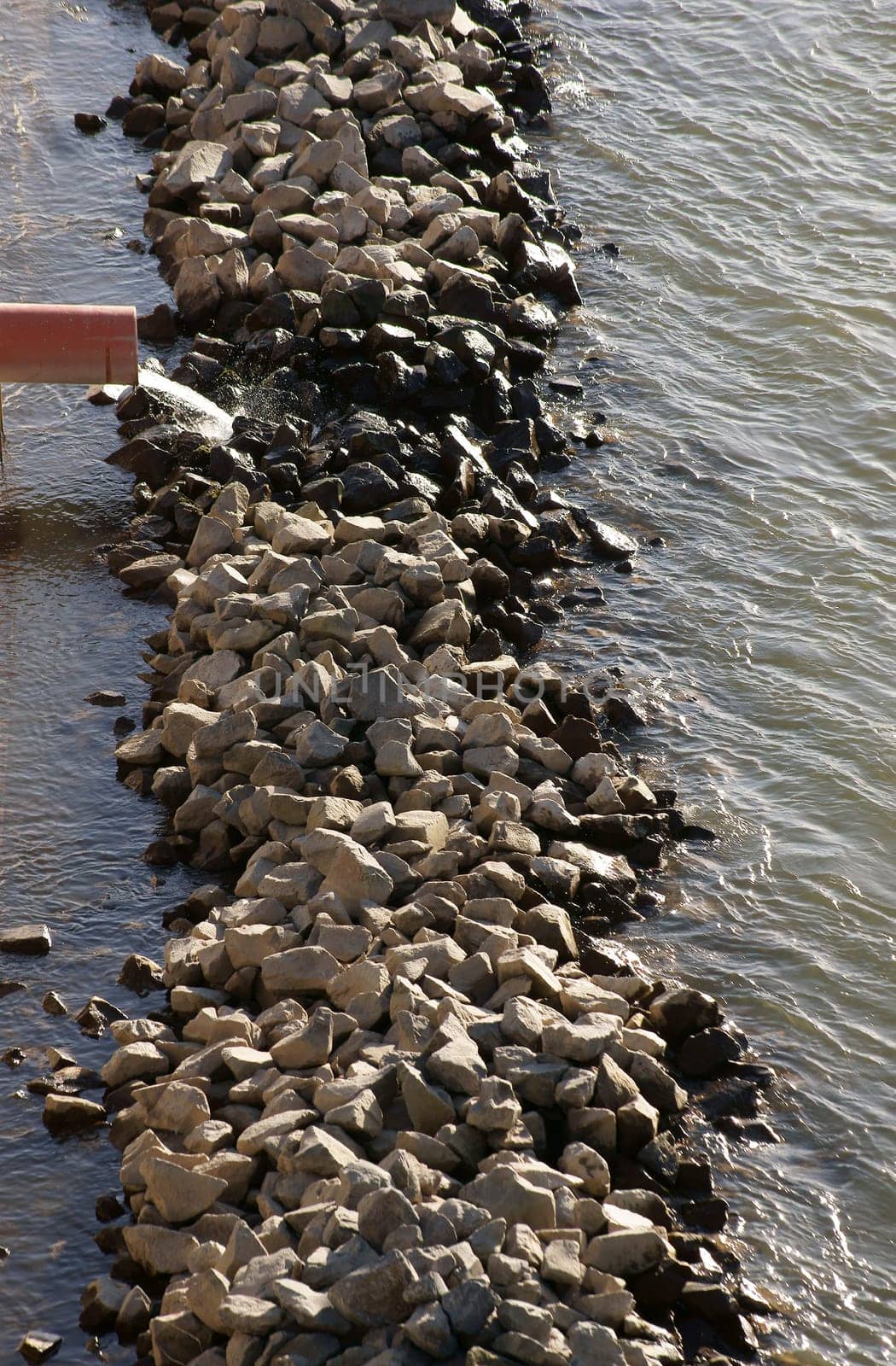 The photograph of an industrial drain into the river Rhine.