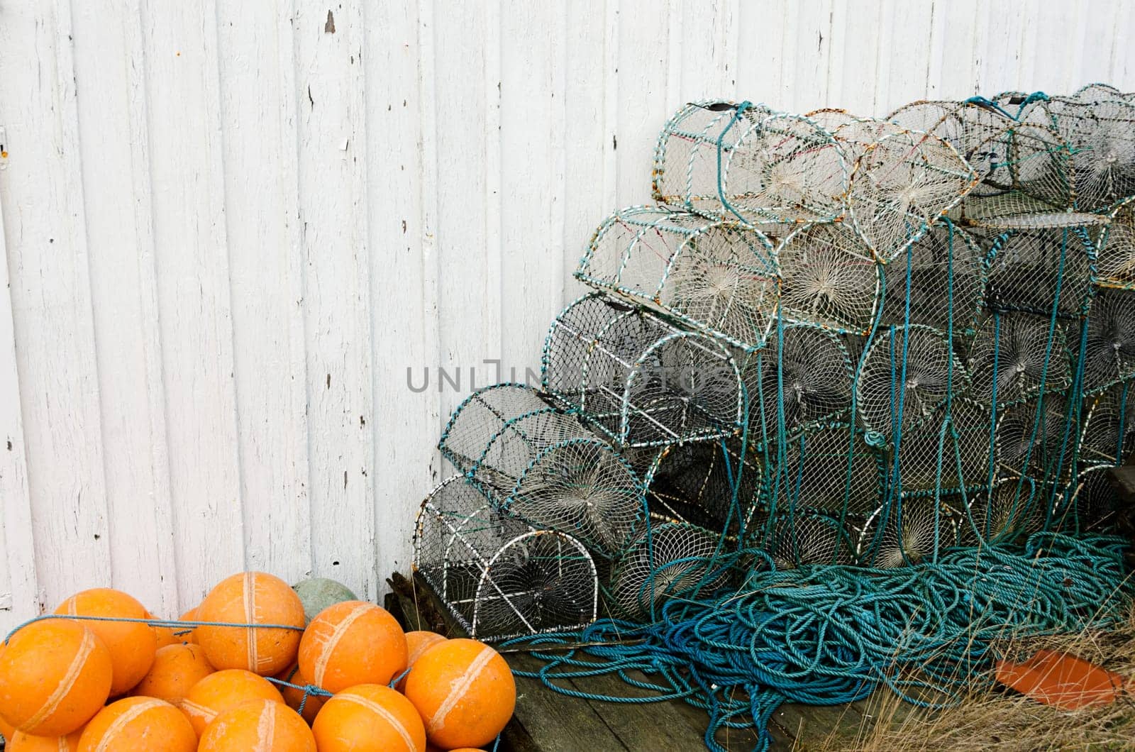 Lobster pots against a wall waiting to be used