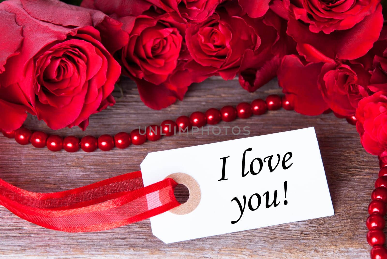 Label with the Word I love you and roses as Background