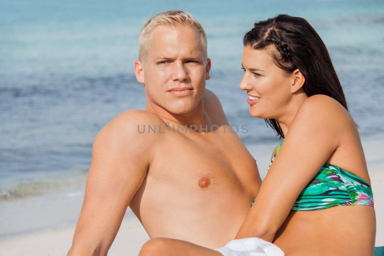 Young happy couple in love on the beach in summer holidays leisure rest recreation holiday sun