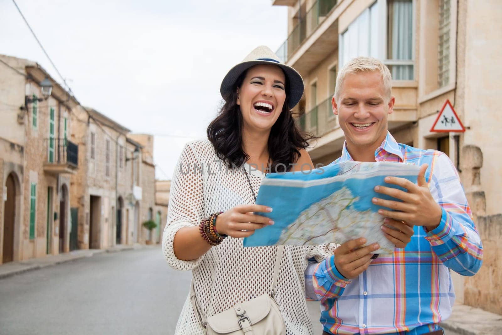 Young attractive couple in summer in the city Tourists Travel Map Search for directions