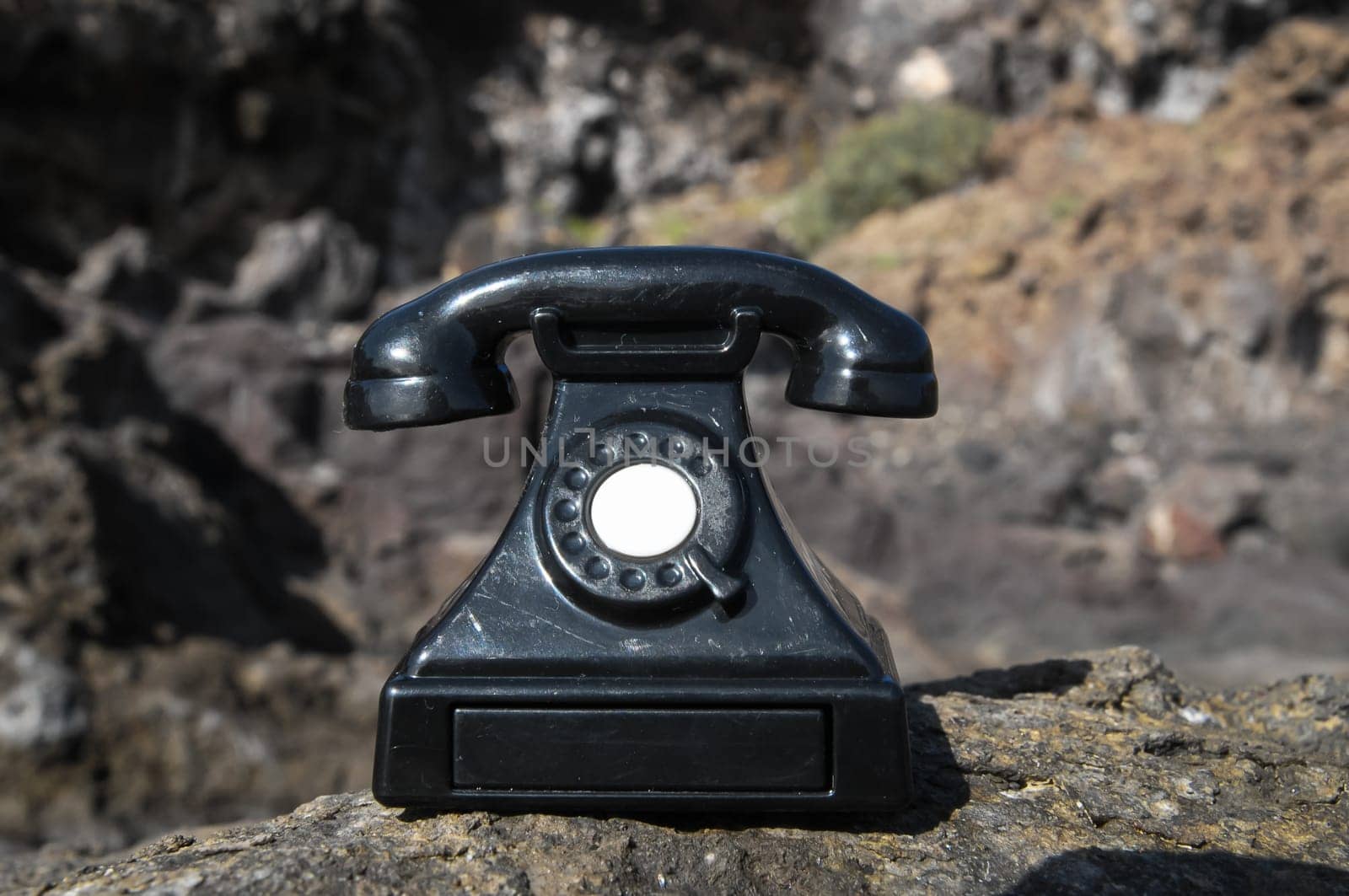 International Communications Vintage Telephone Toy on the Volcanic Rocks