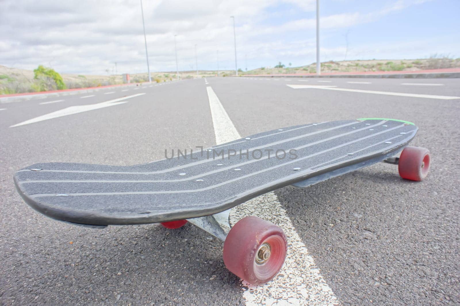Hdr Picture Vintage Style Longboard Black Skateboard on an Empty Asphalt Desert Road