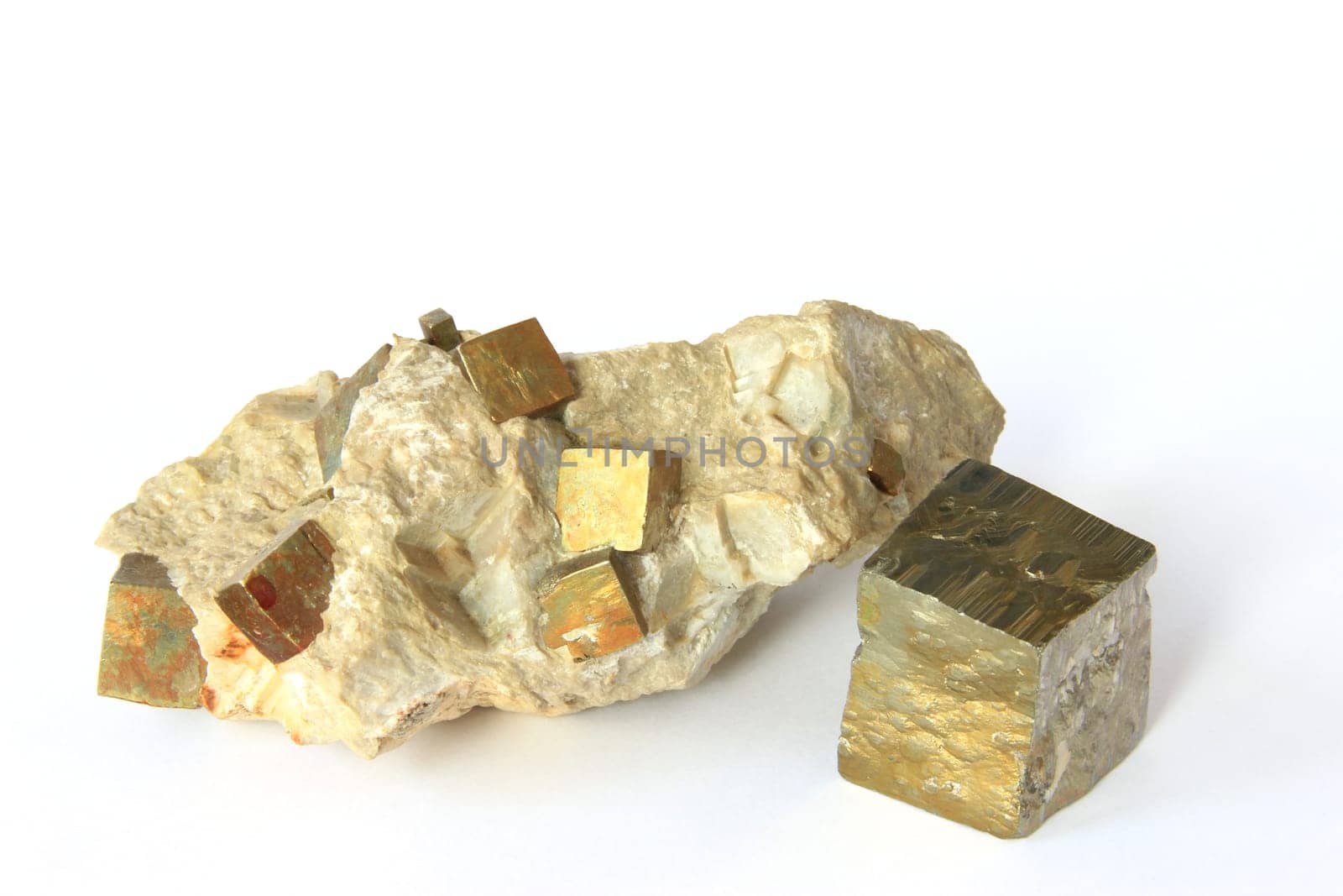 Pyrite crystals in the host rock and single cube-shaped crystal