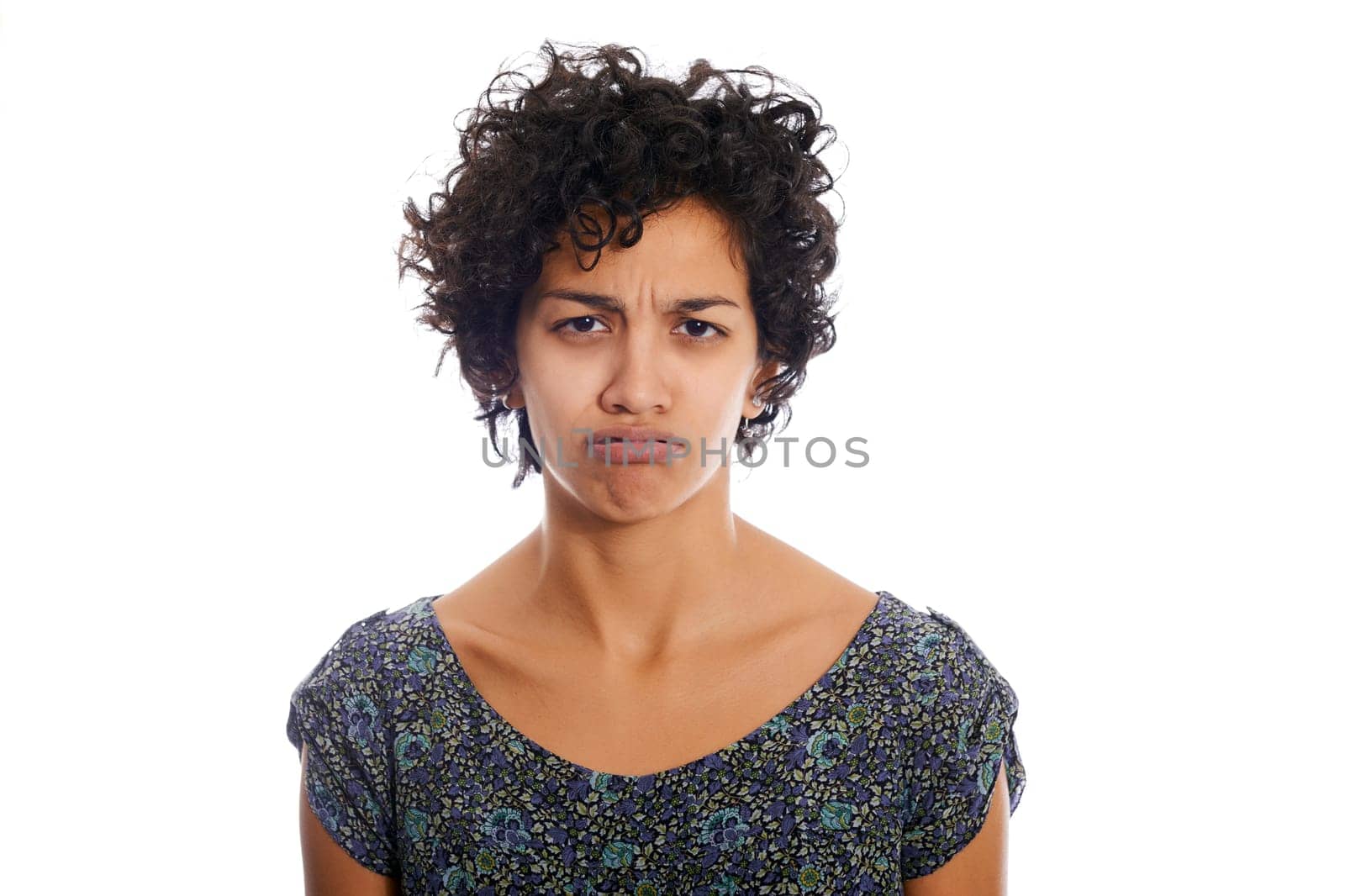 portrait of hispanic woman looking at camera upset and sad. Isolated on white background