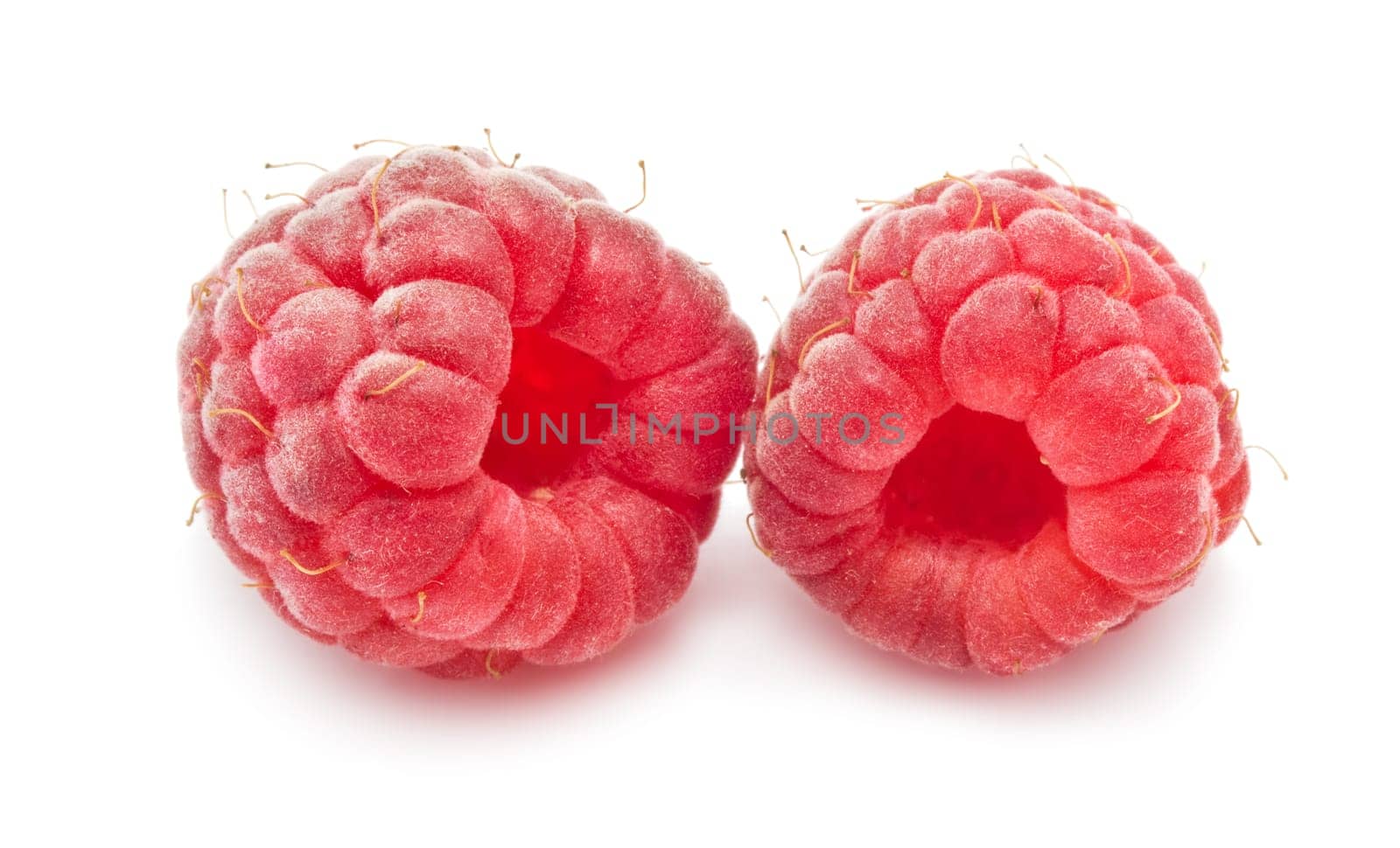 Ripe red raspberries isolated on white background