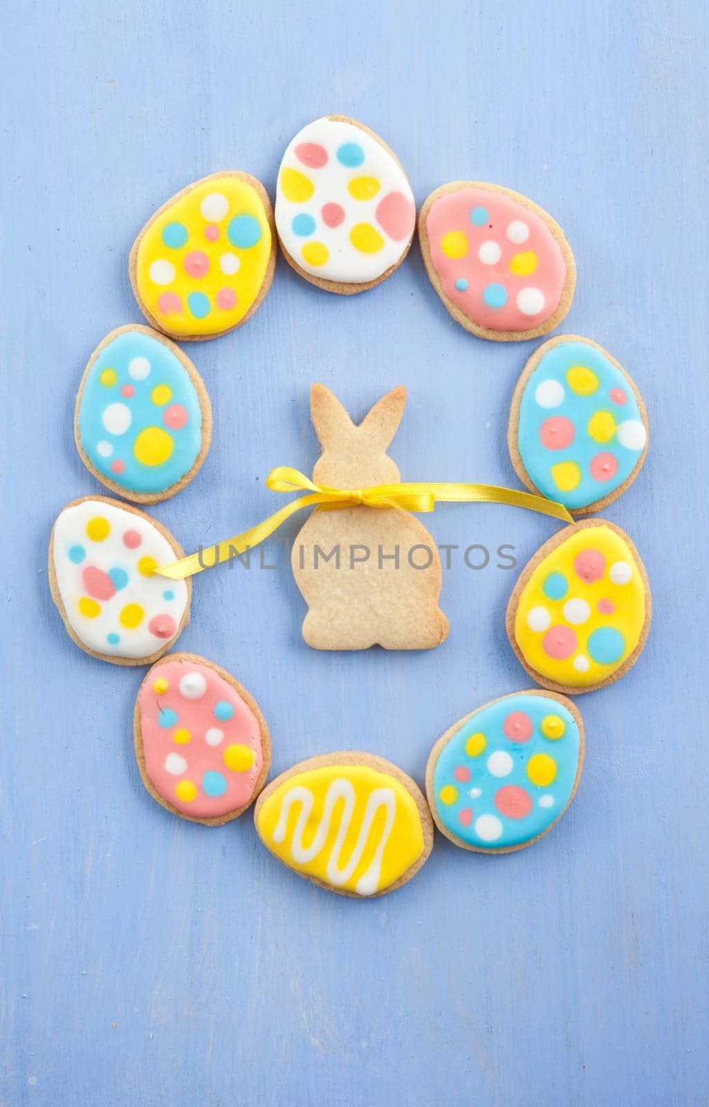 Colorful cookies for Easter on blue wooden background