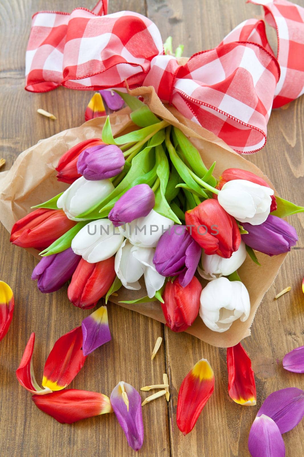 Colourful bouquet of tulips on rustic wood