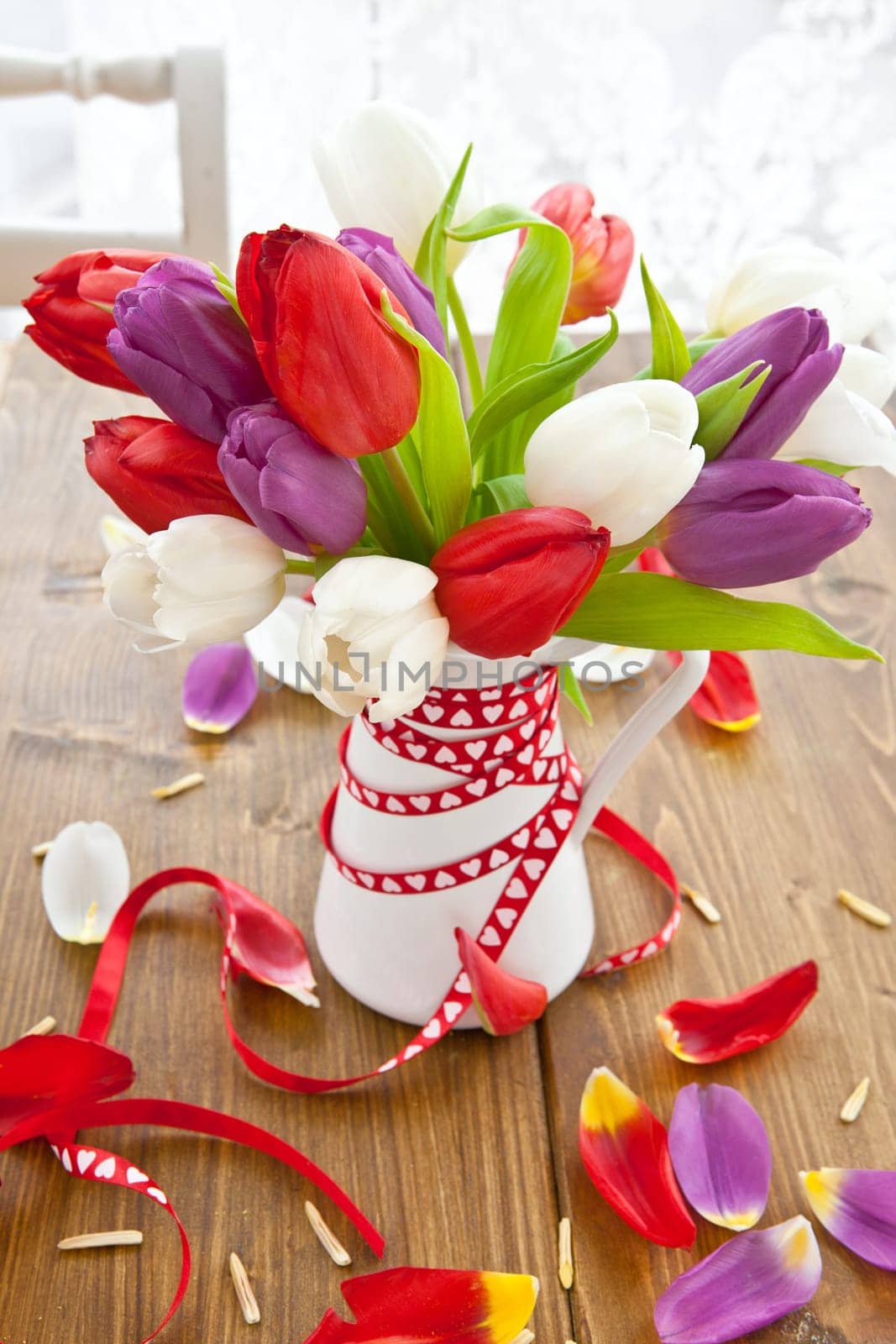 Colourful bouquet of tulips on rustic wood