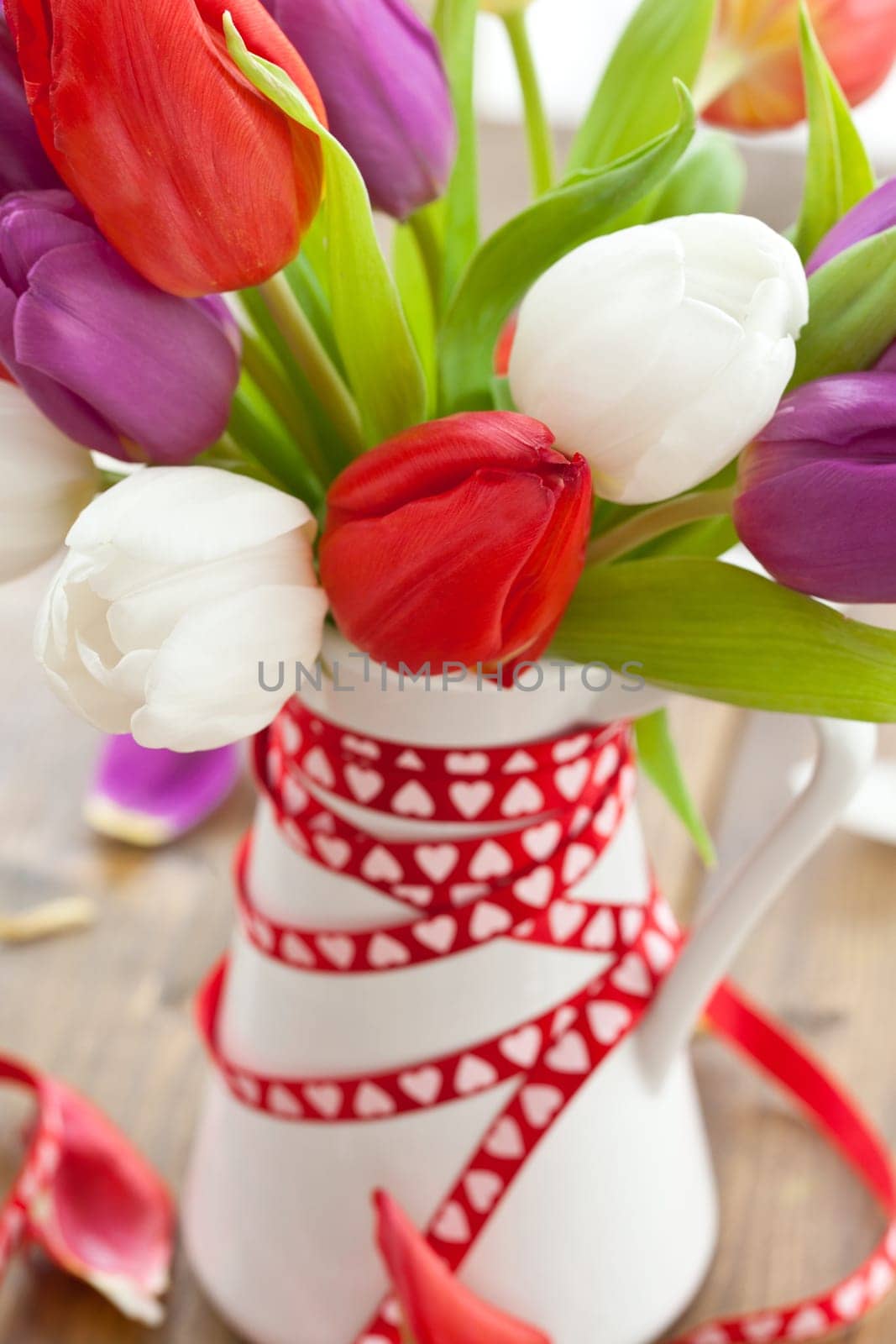 Colourful bouquet of tulips on rustic wood