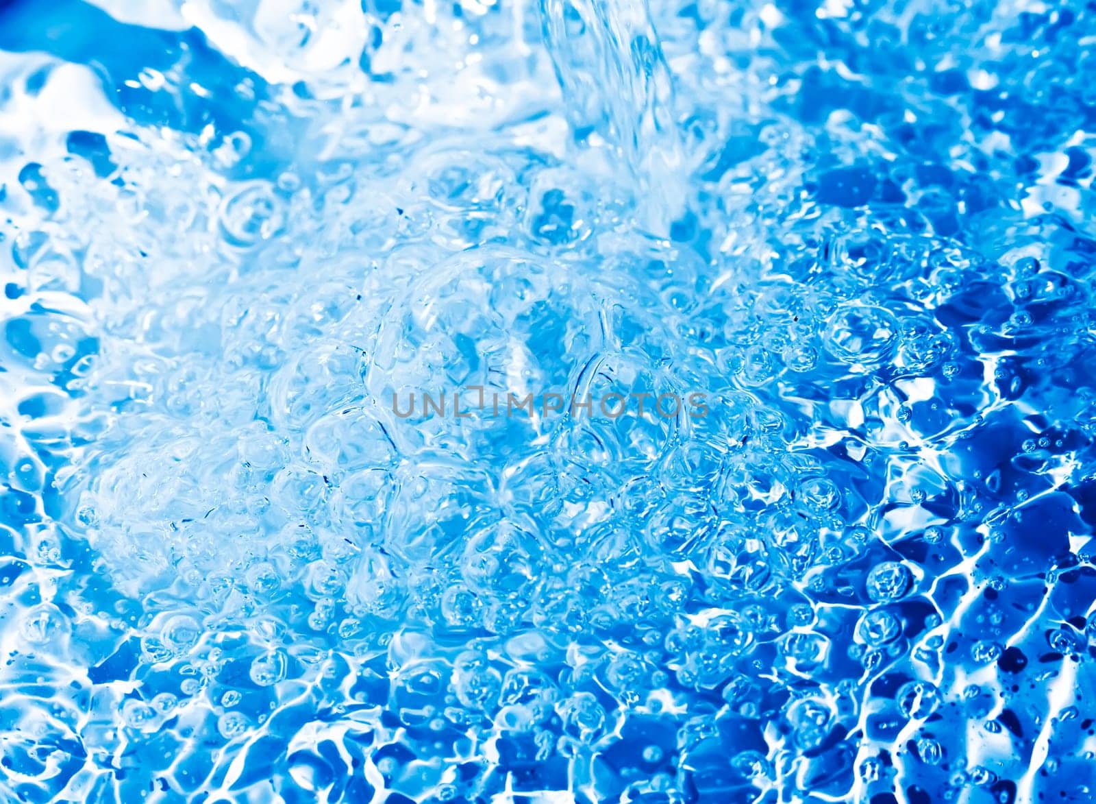 Blue transparent water splashes on white background