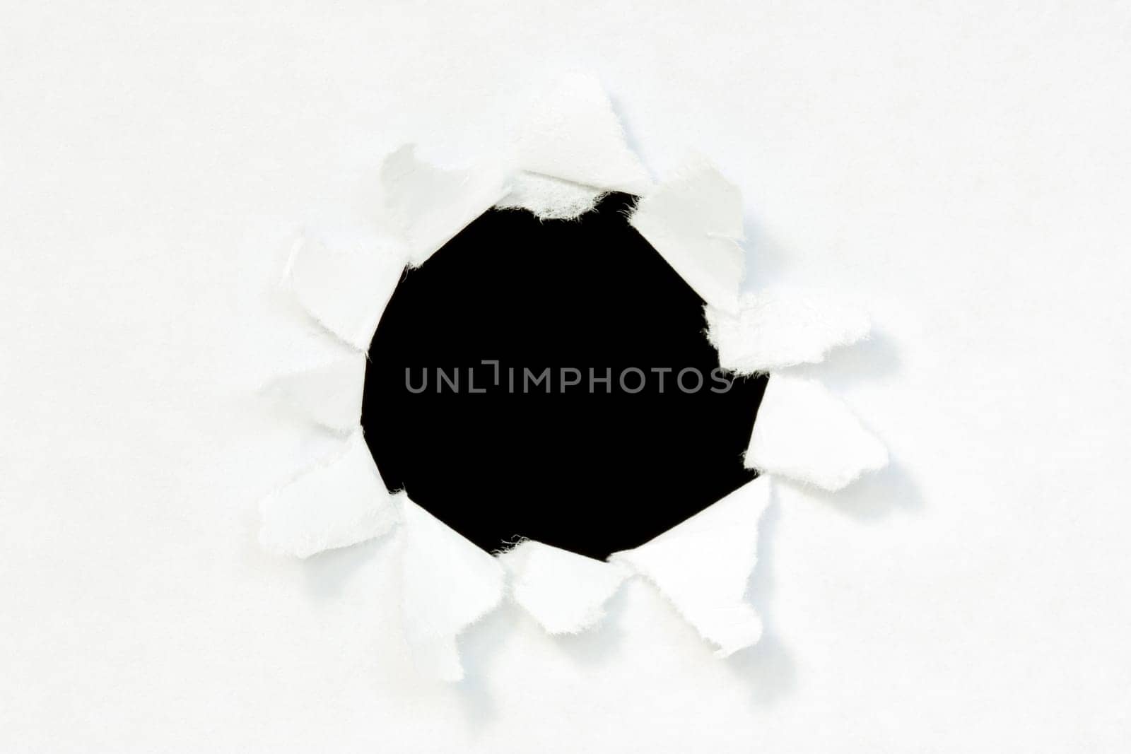 Hole in a paper with black background inside