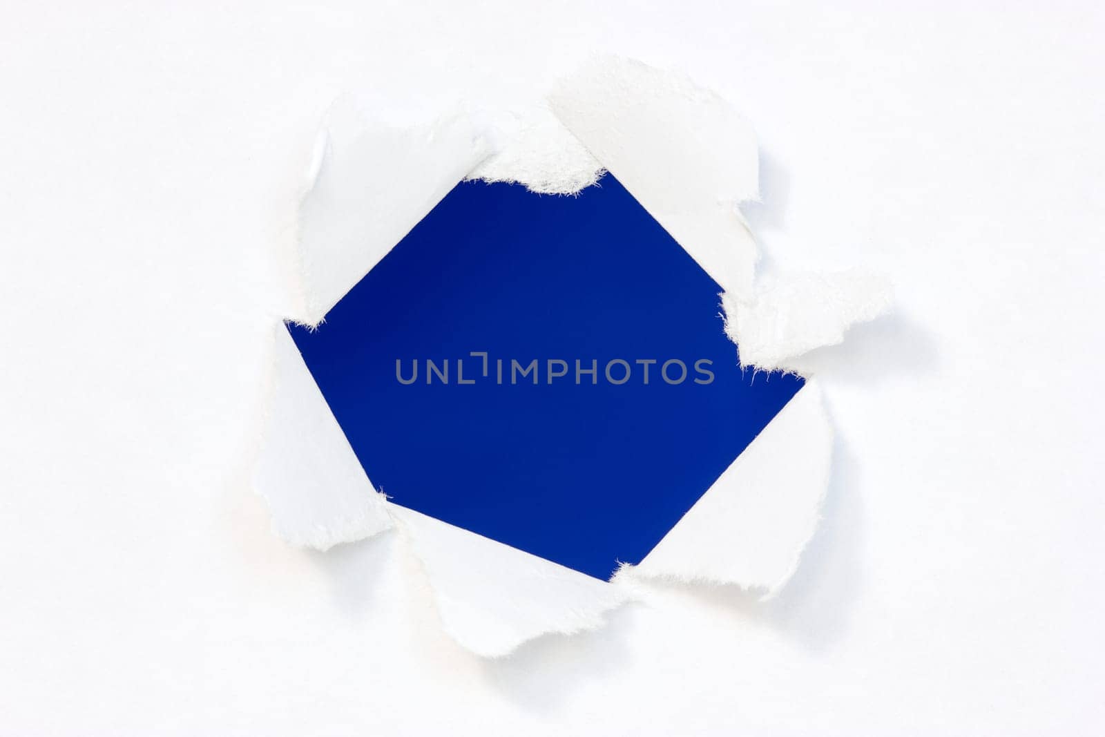 Hole in a paper with blue background inside