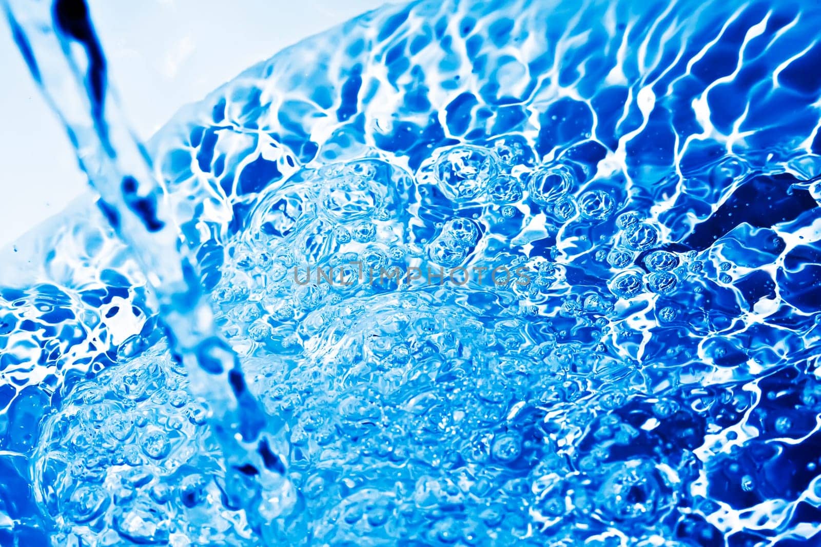 Blue transparent water splashes on white background