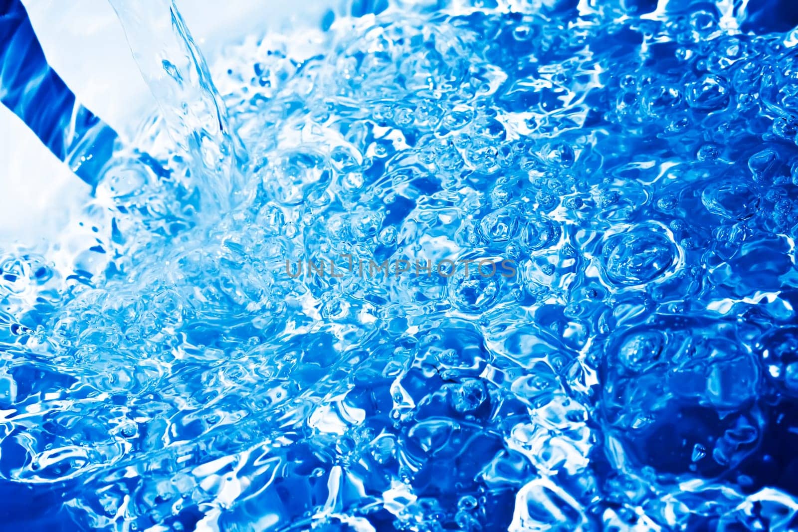 Blue transparent water splashes on white background