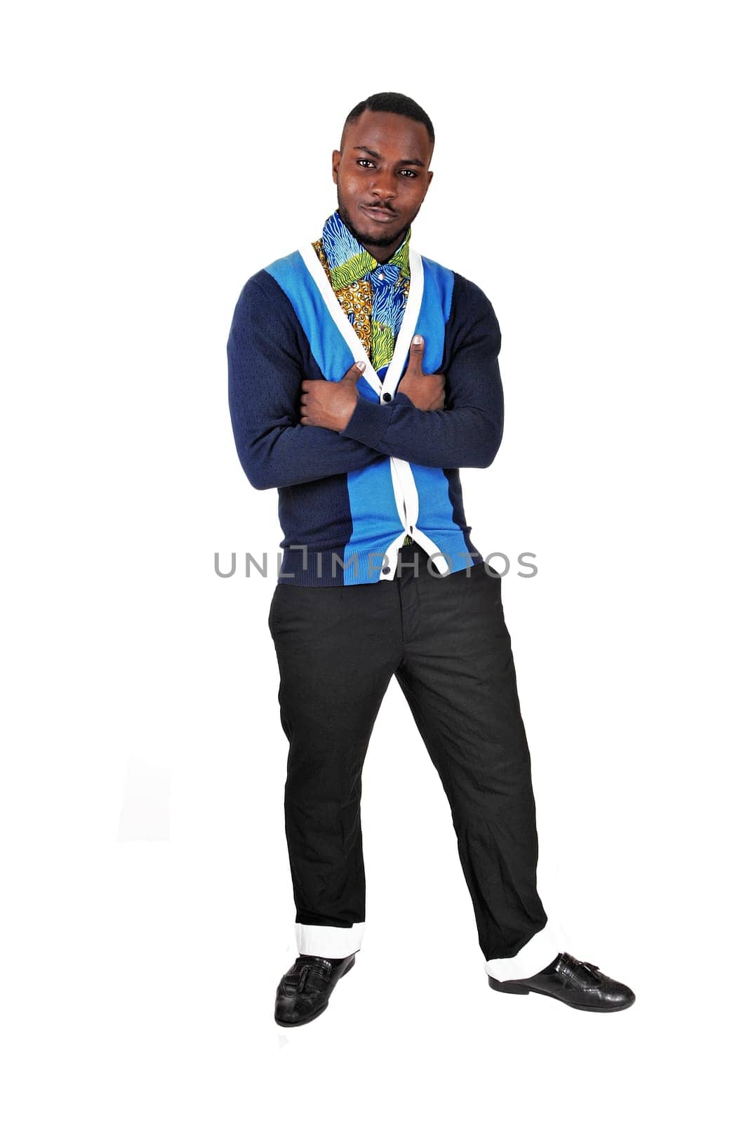 A black young man standing for white background with his arms crossed.smiling into the camera..