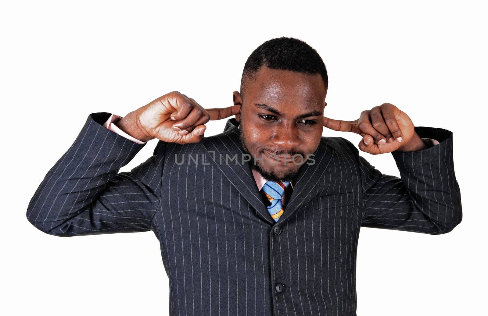 Young black businessman putting his fingers in his ears, dos not like.to hear..