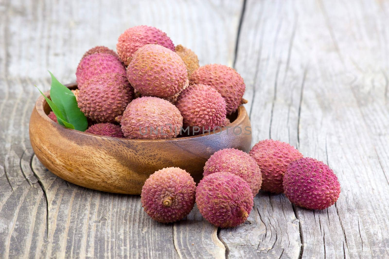 fresh lychees in a bowl  on wooden background