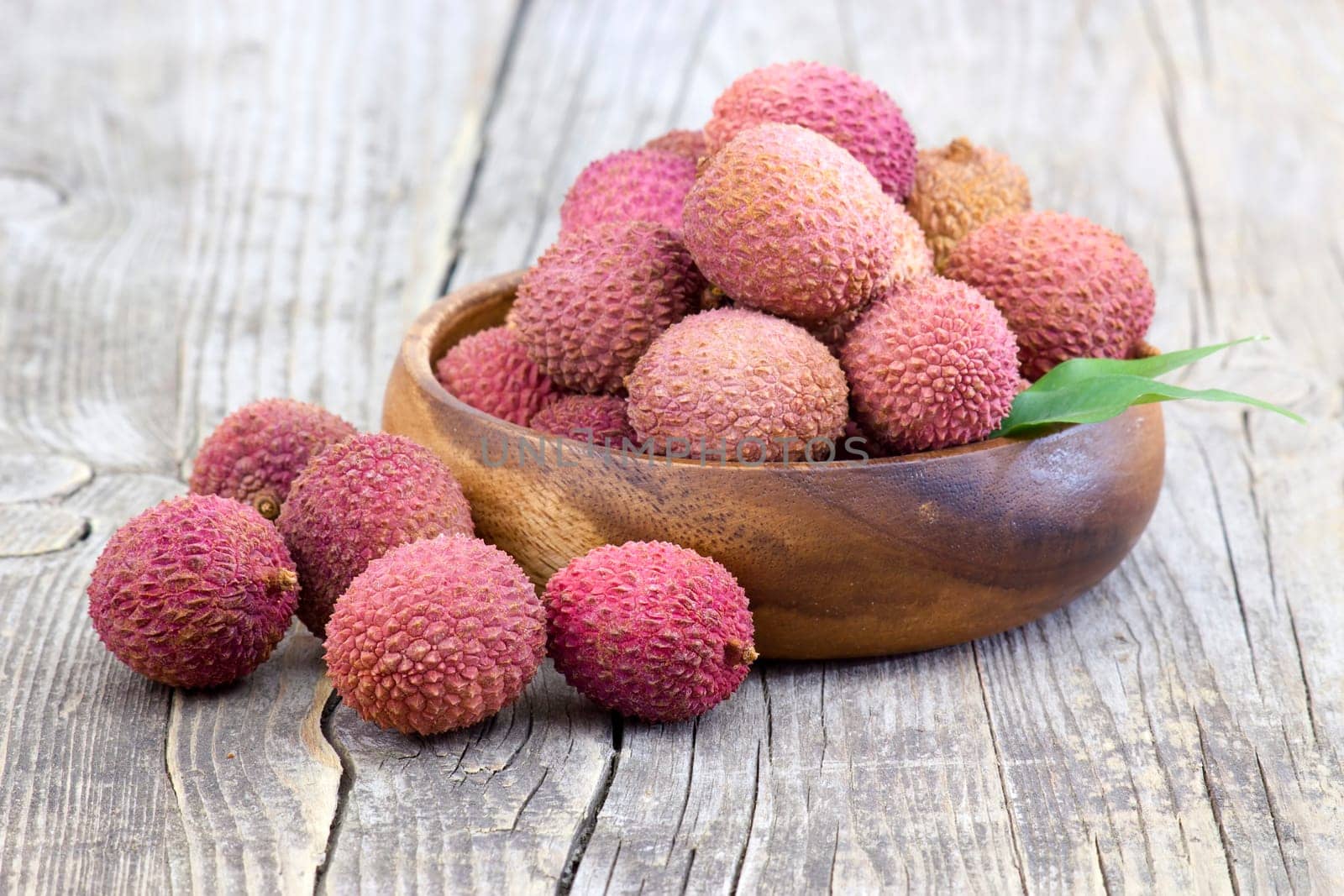 fresh lychees in a bowl  on wooden background