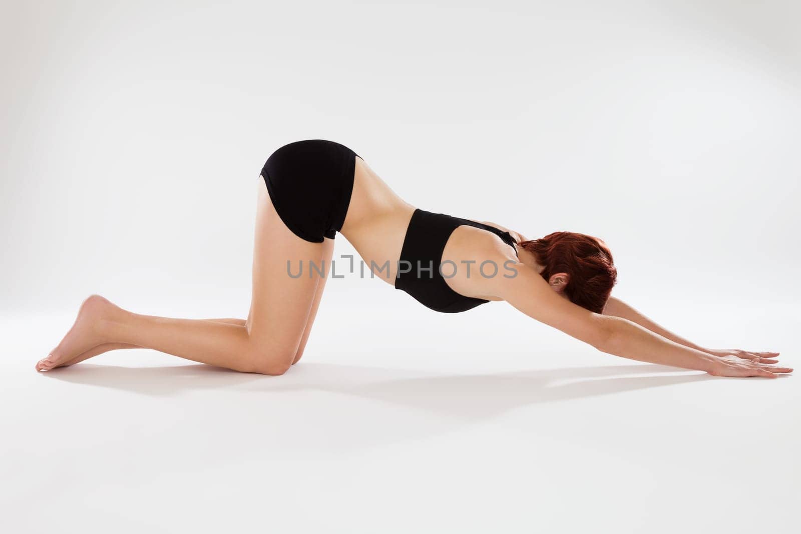 Young sporty woman doing fitness exercises