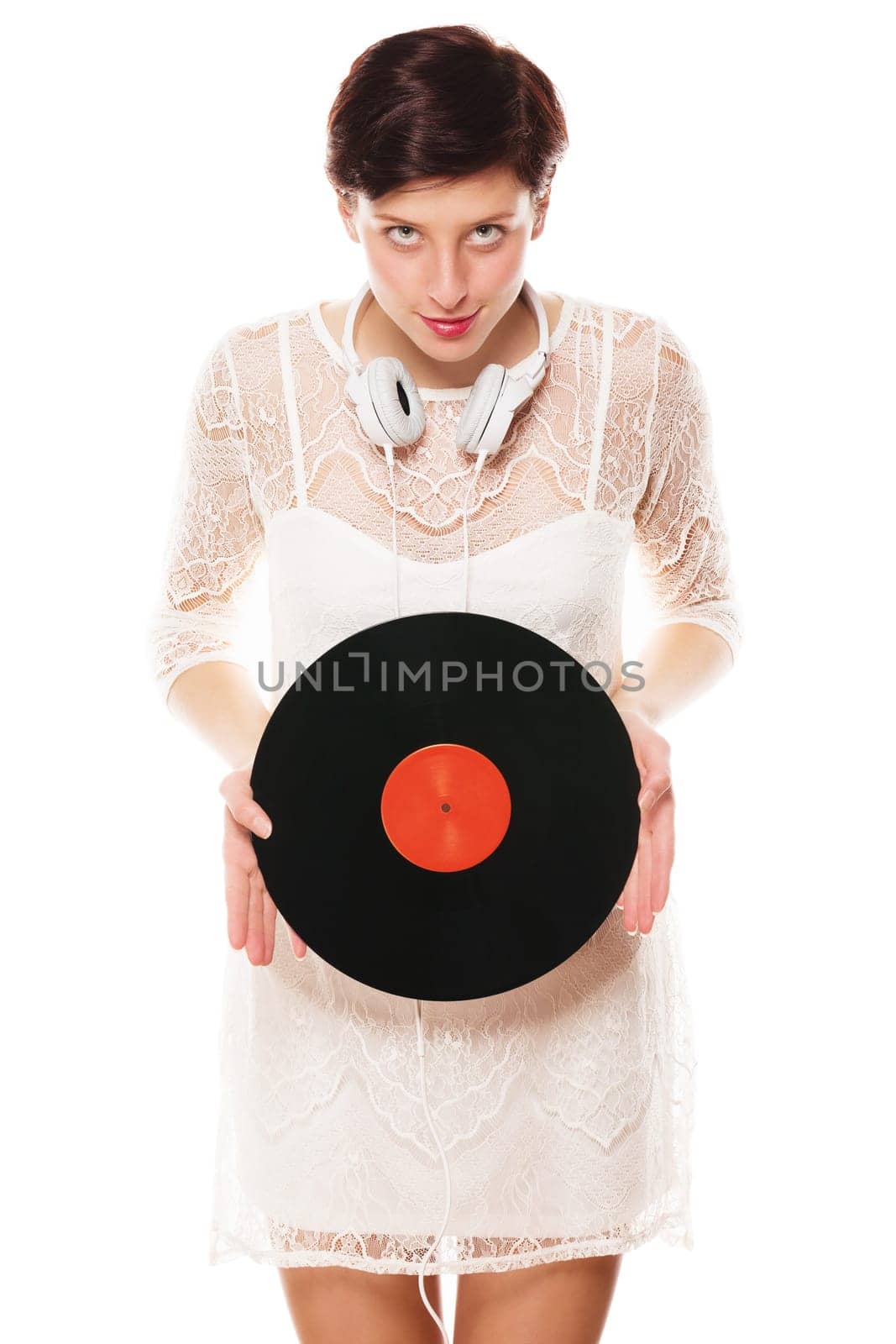 Young Veschmitze woman with headphones holds record in front of a white background