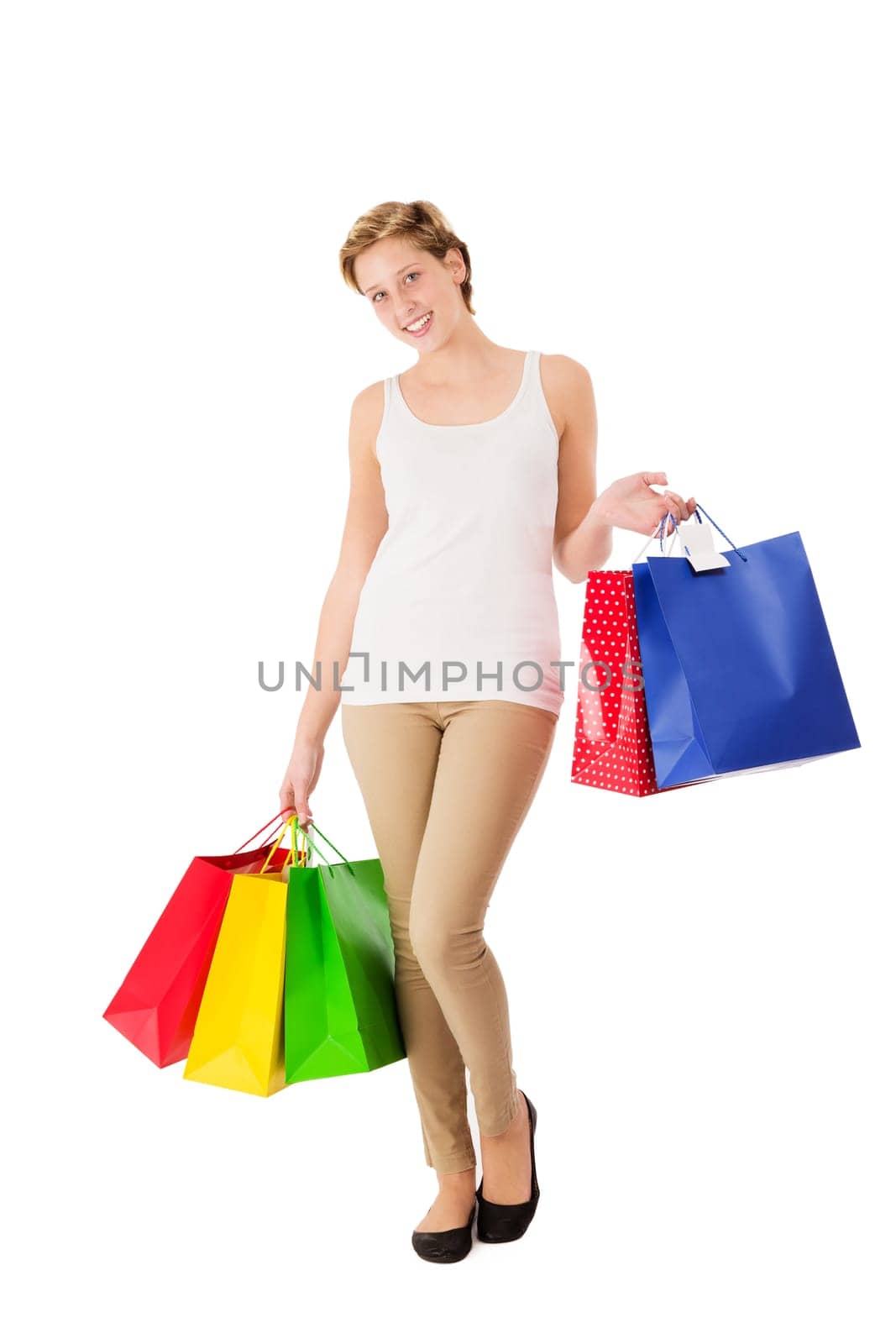 Happy young woman with shopping bags shopping in front of a white background