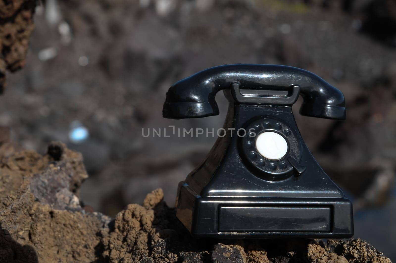 International Communications Vintage Telephone Toy on the Volcanic Rocks