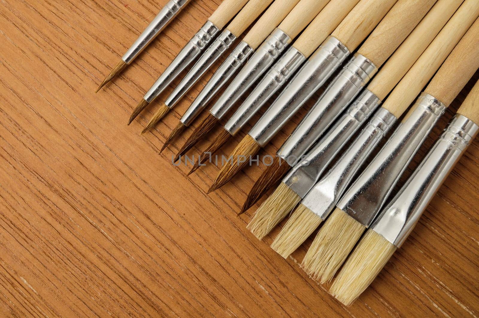 New Wooden Different Paintbrush Set Texture over a Colored Background
