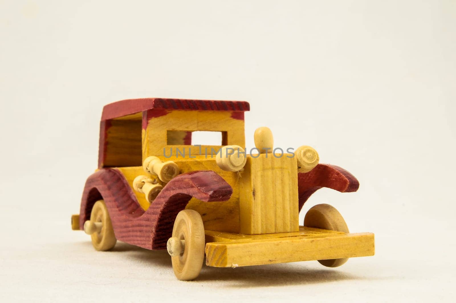Wooden Toy Red and Yellow Car on a white Backgraund