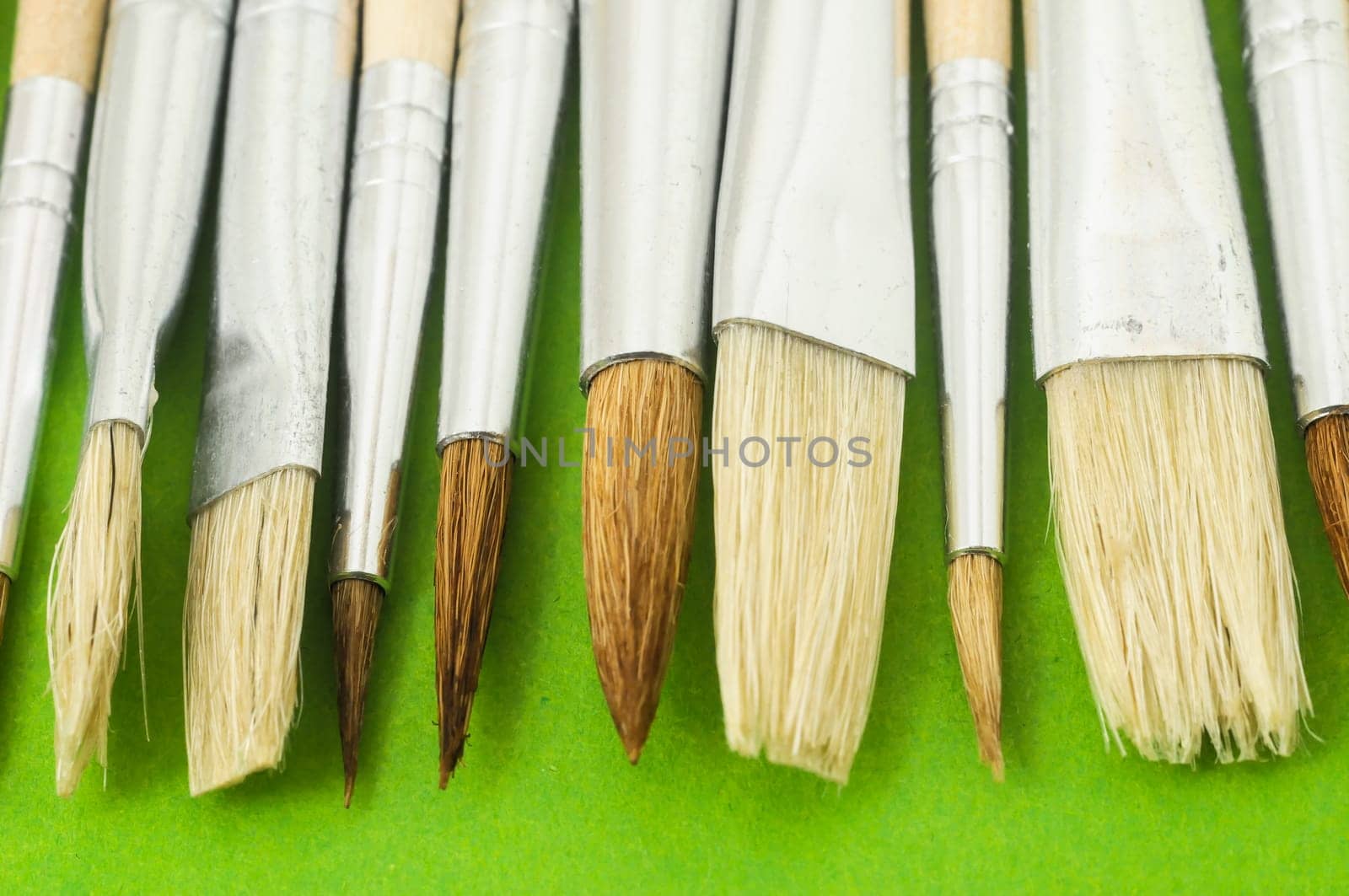 New Wooden Different Paintbrush Set Texture over a Colored Background