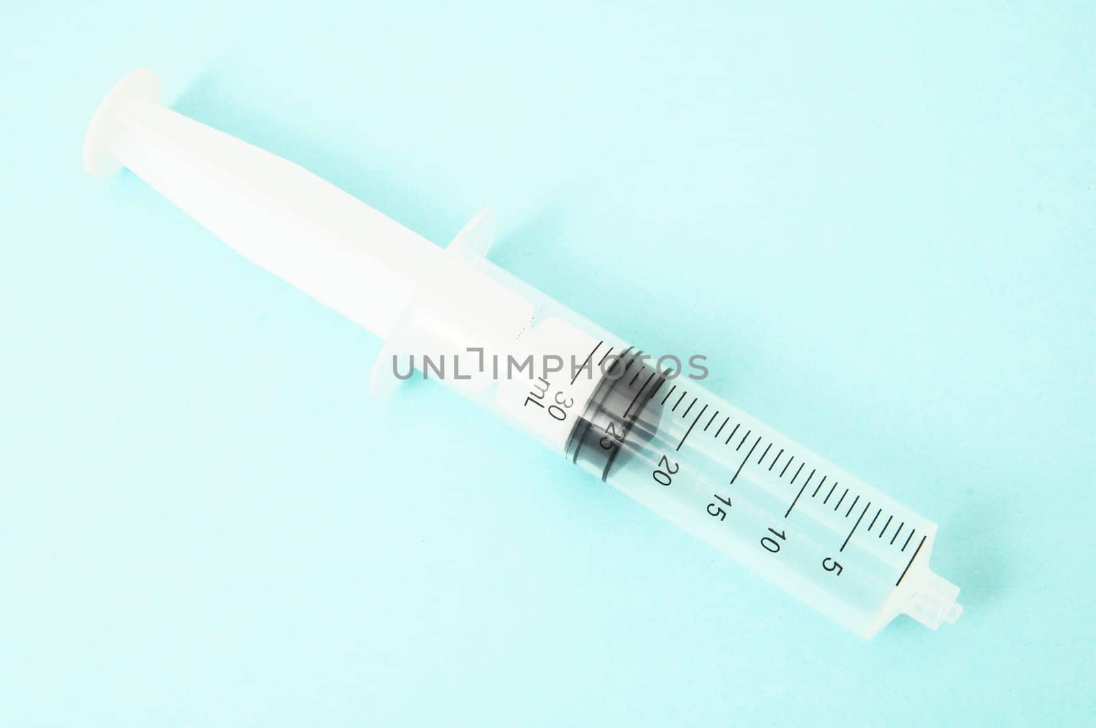 Big Black and White Syringe on a Colored Background