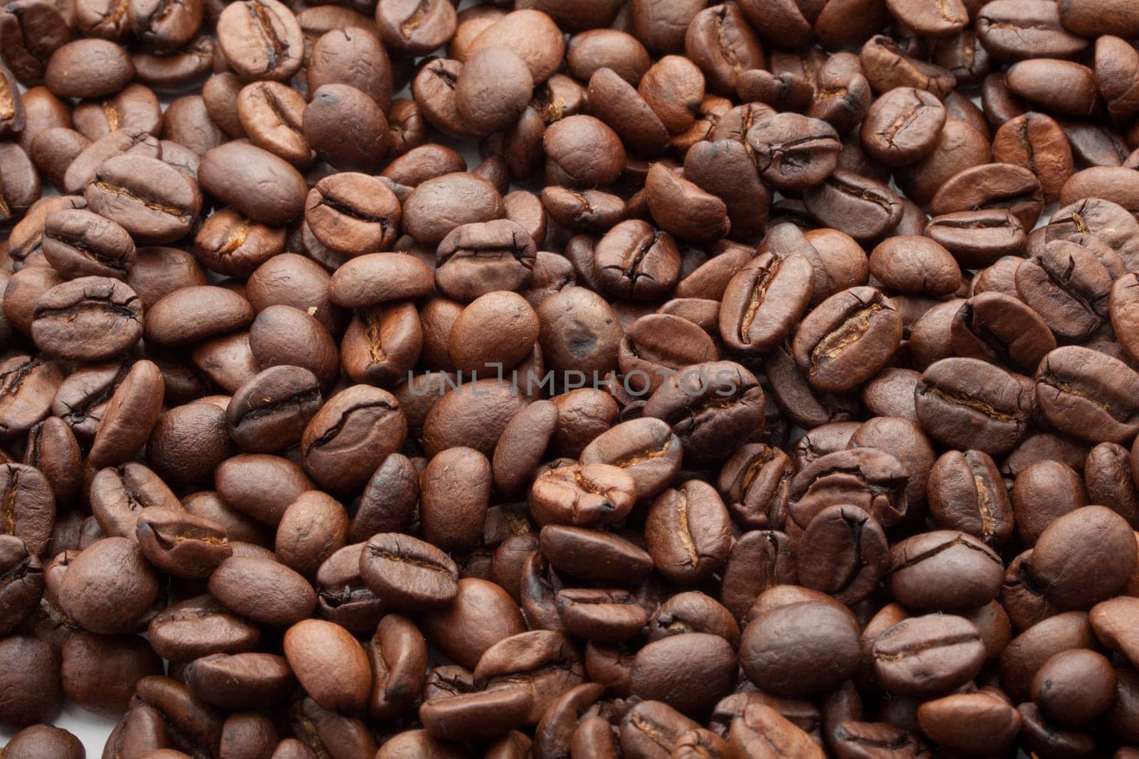 Close-up of brown coffee beans, background texture