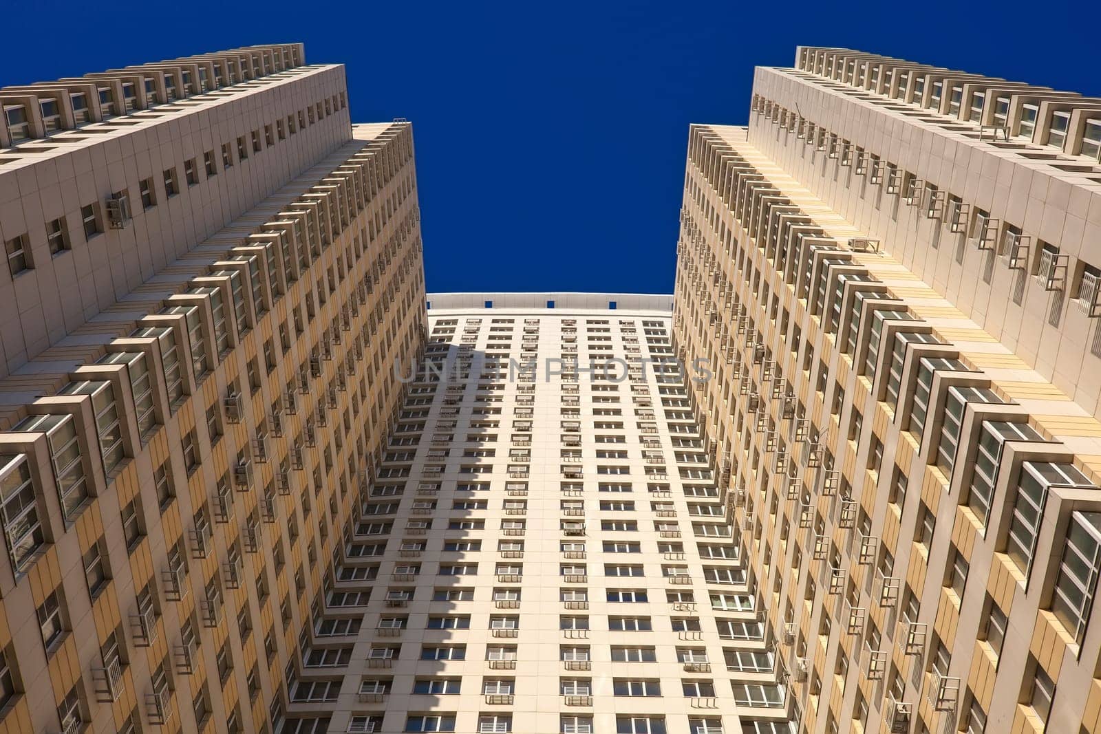 Beautiful view of modern apartment building under blue sky