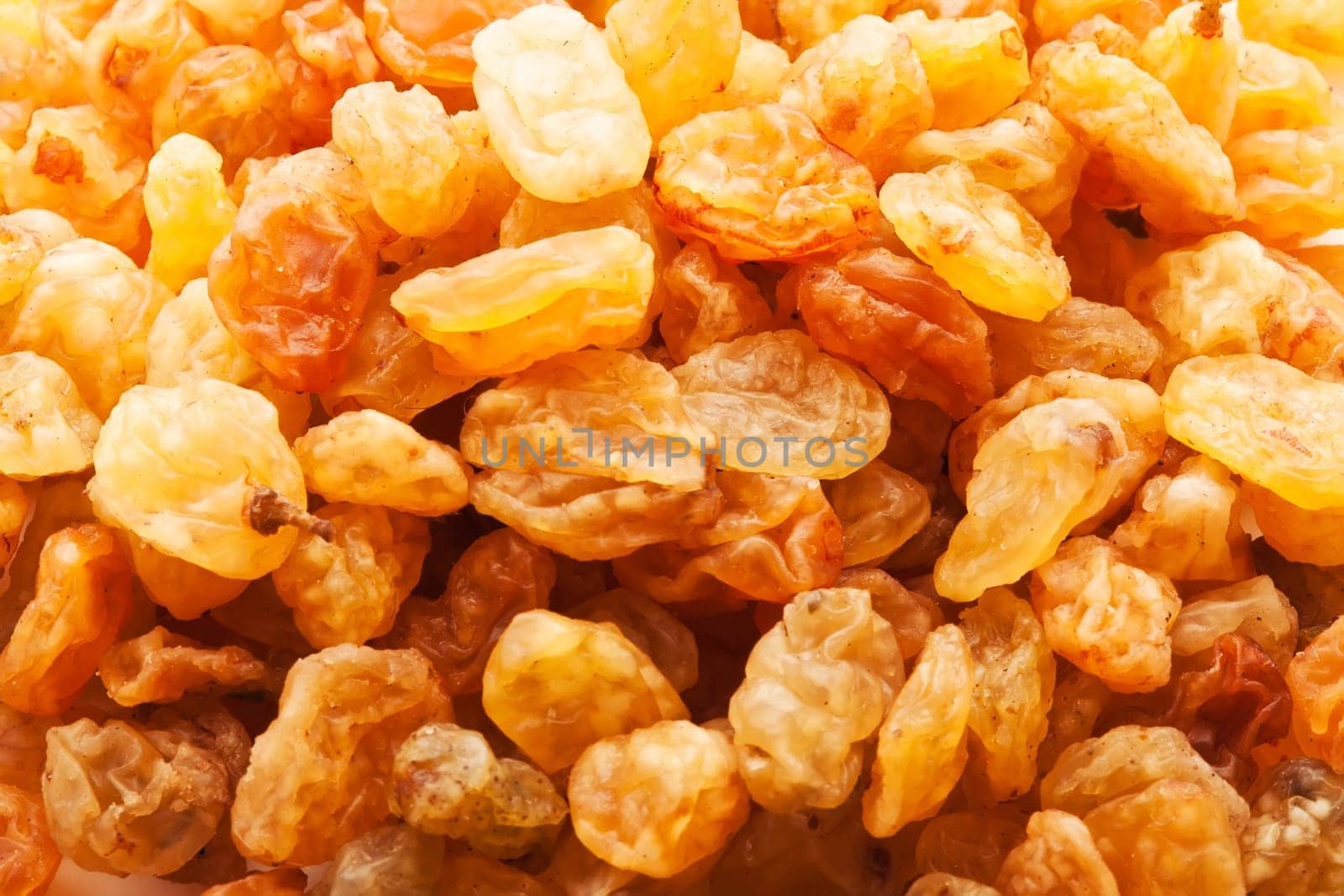 Heap of raisins - golden dried grapes background