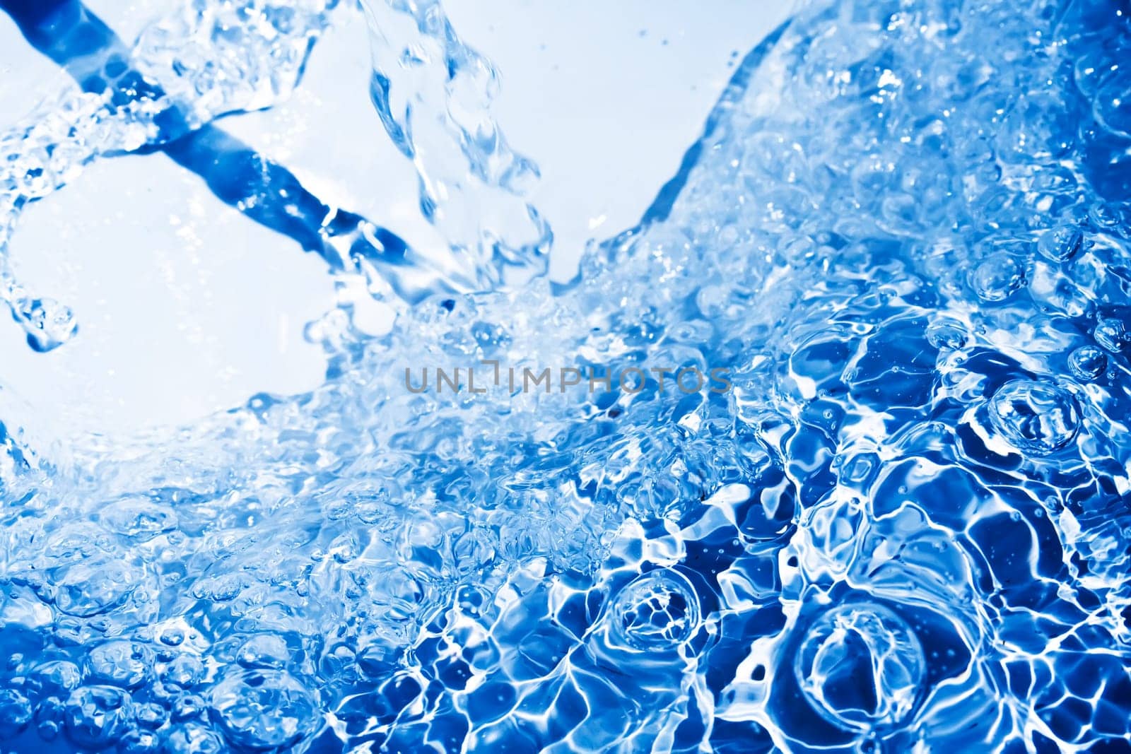 Blue transparent water splashes on white background