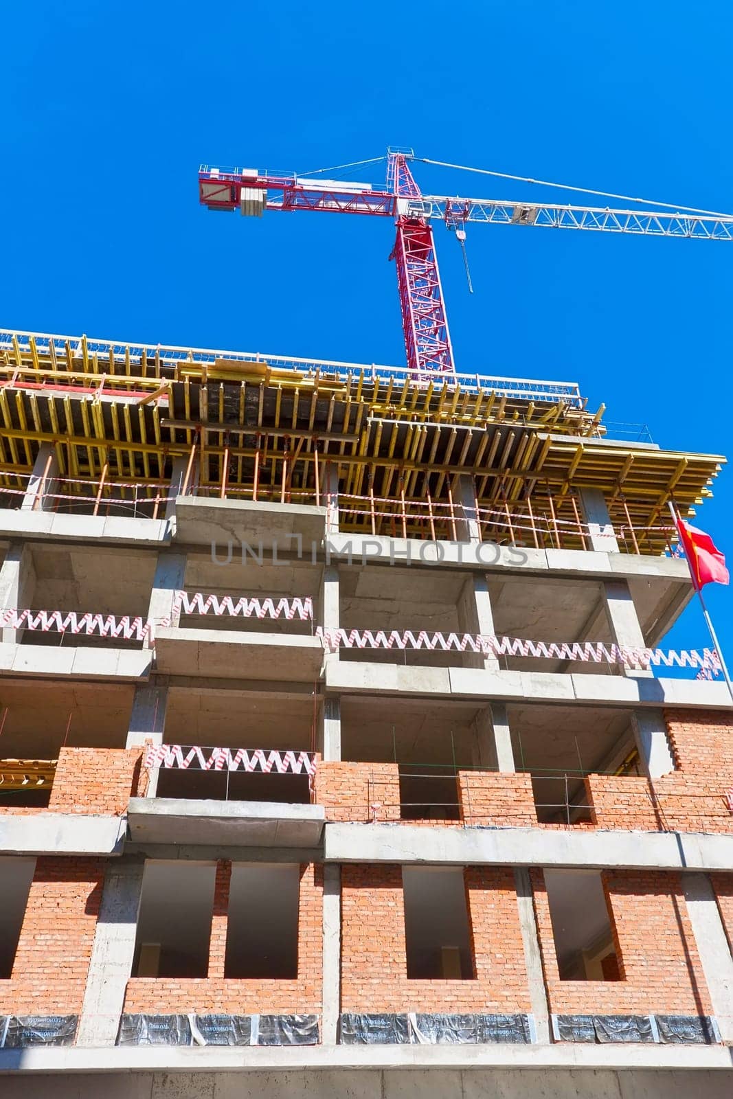 Construction of modern apartment building under blue sky