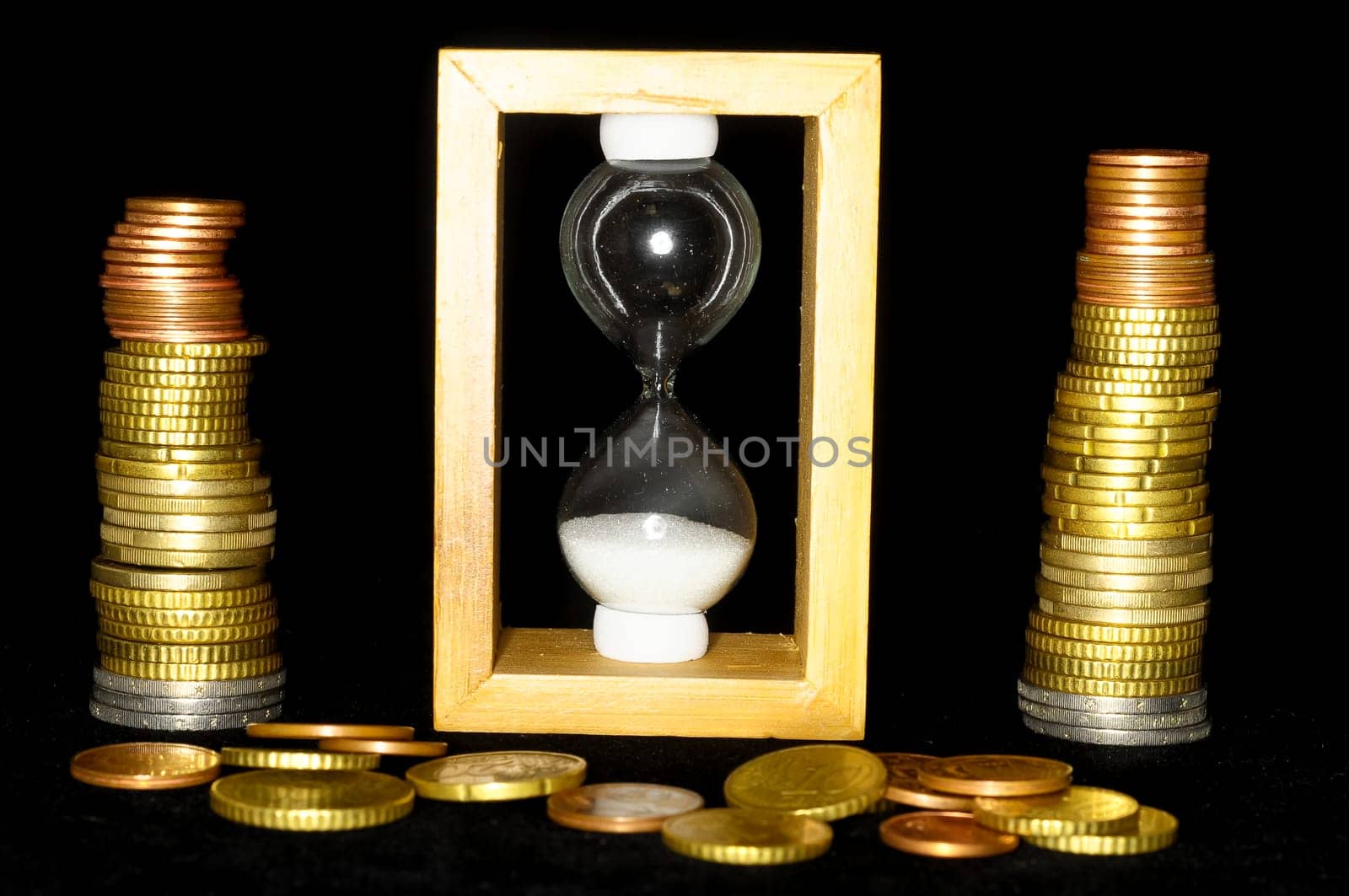 Buisness Time Concept Hourglass and Money on a Black Background