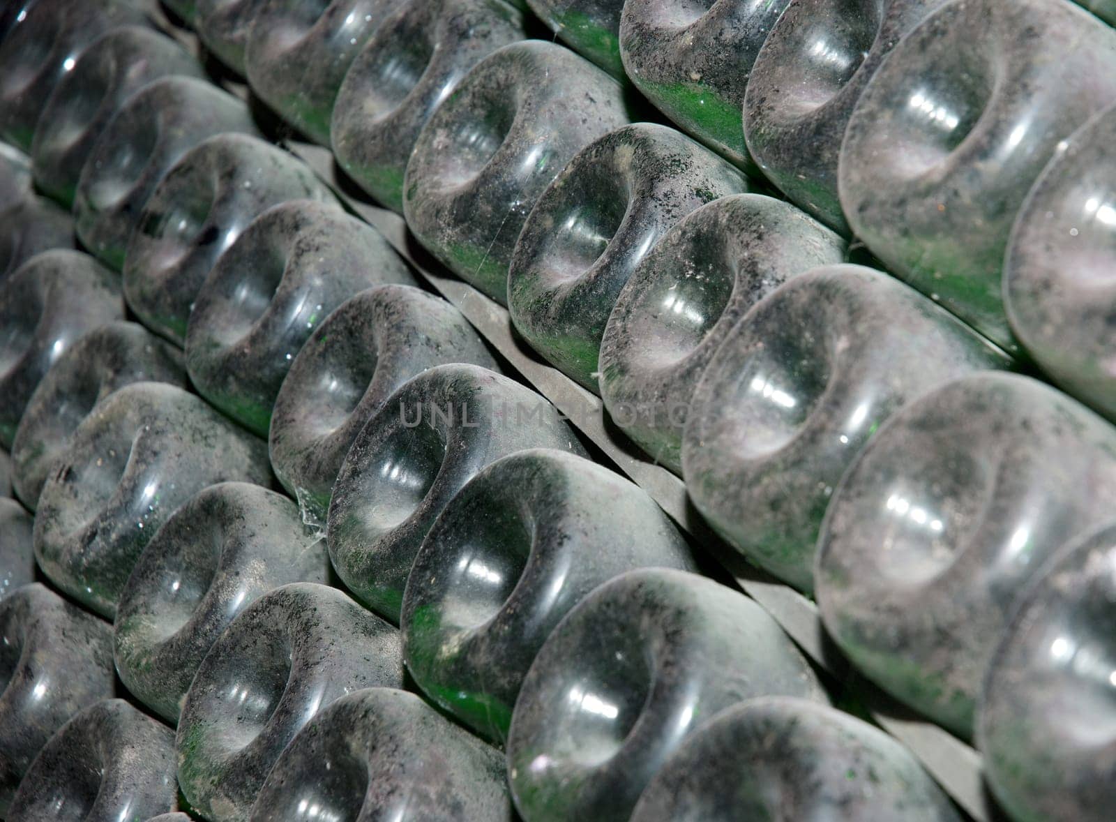Stack of wine bottles in winery. Shampagne wine storage