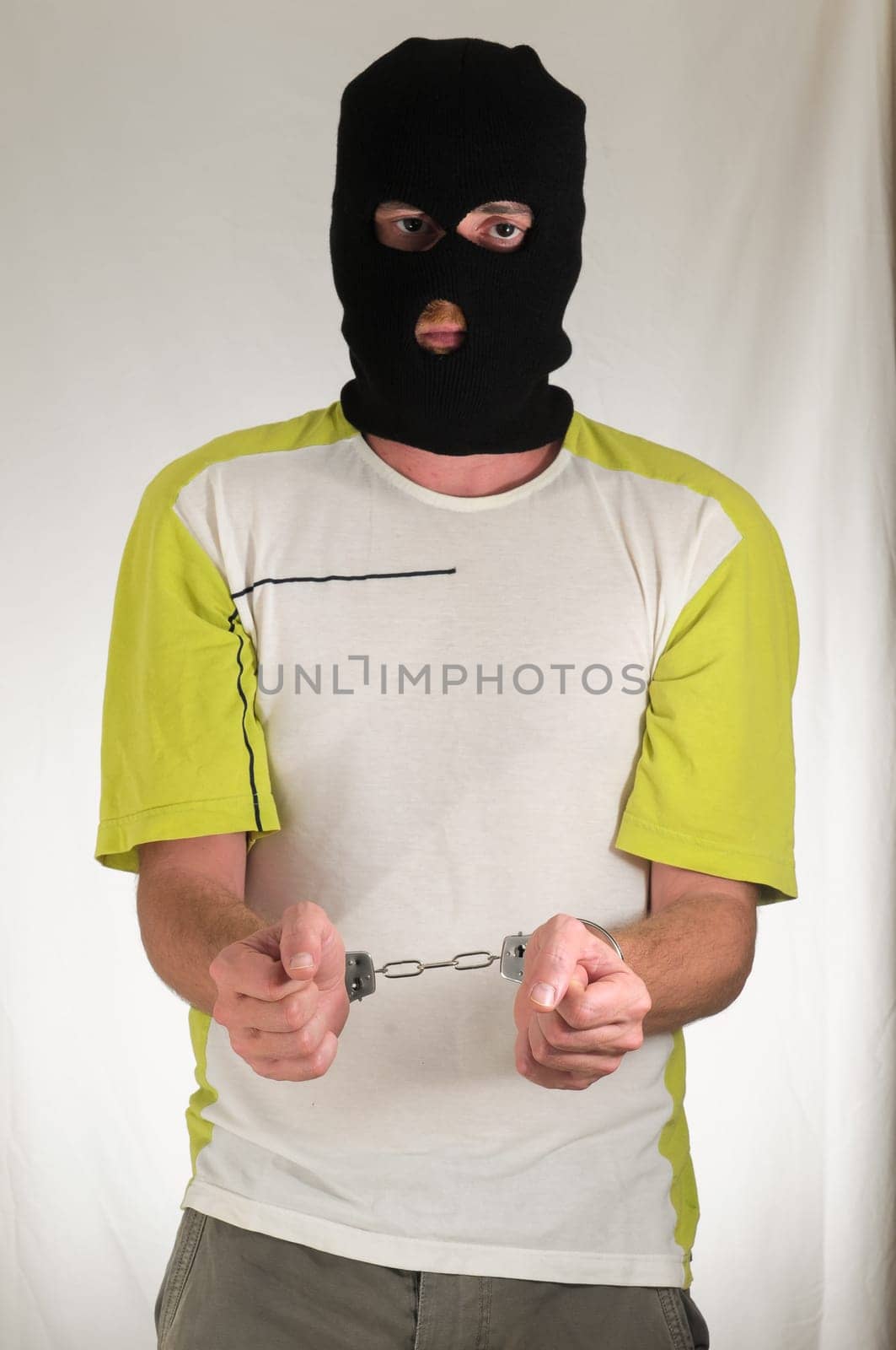 White Dressed Young Man Trapped in Hancduffs