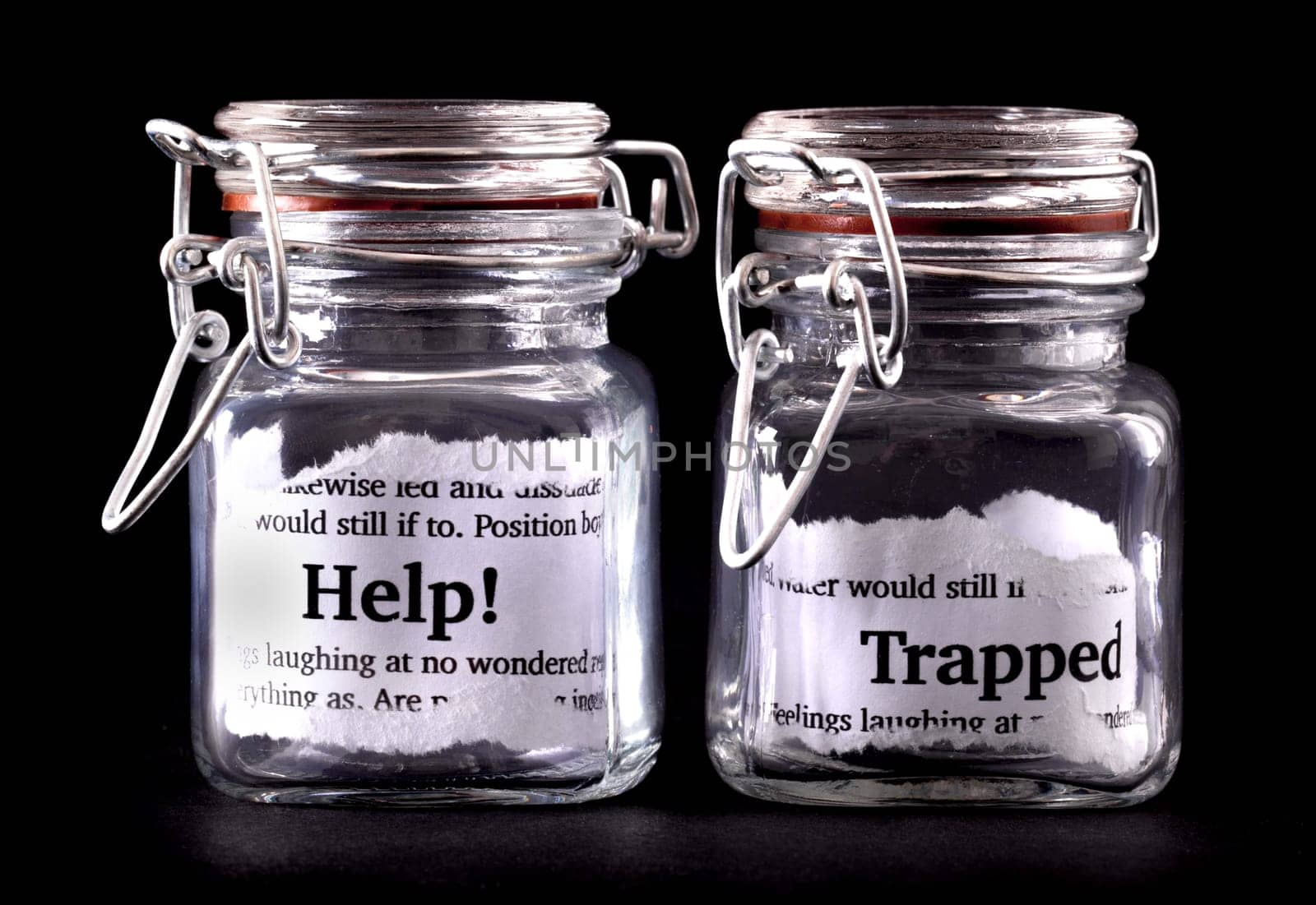 Two closed jars with messages of help and trapped on paper inside