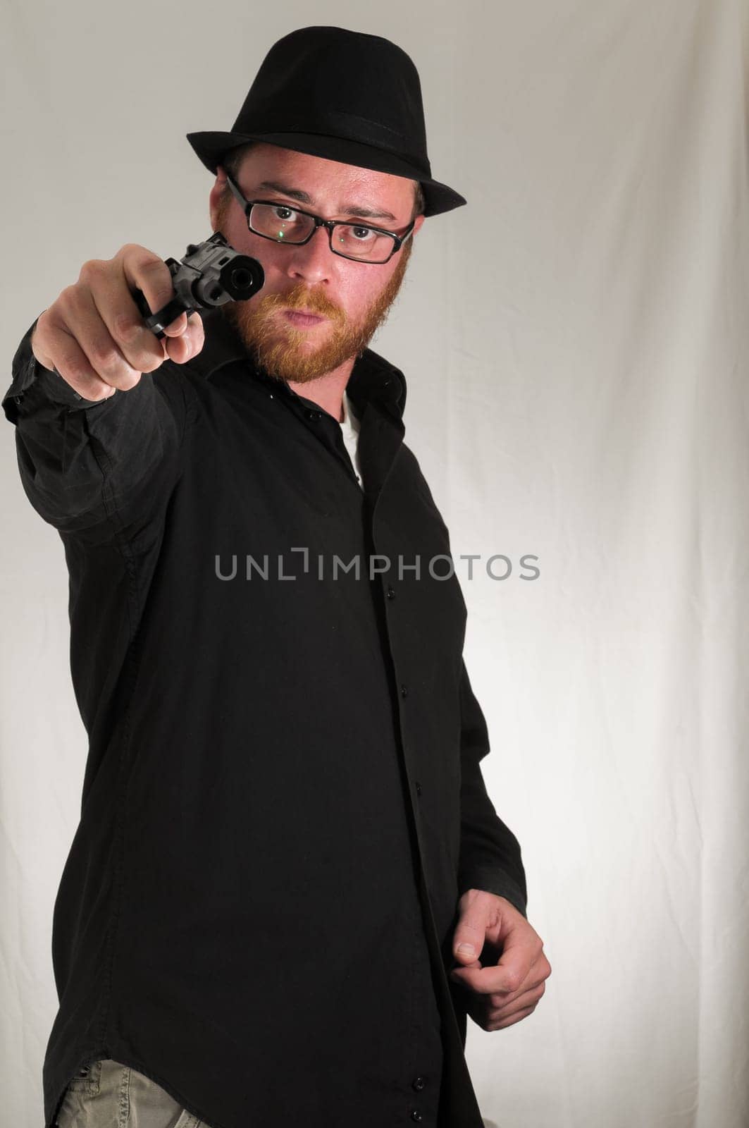 Black Dressed Young Man Holding a Pistol Gun