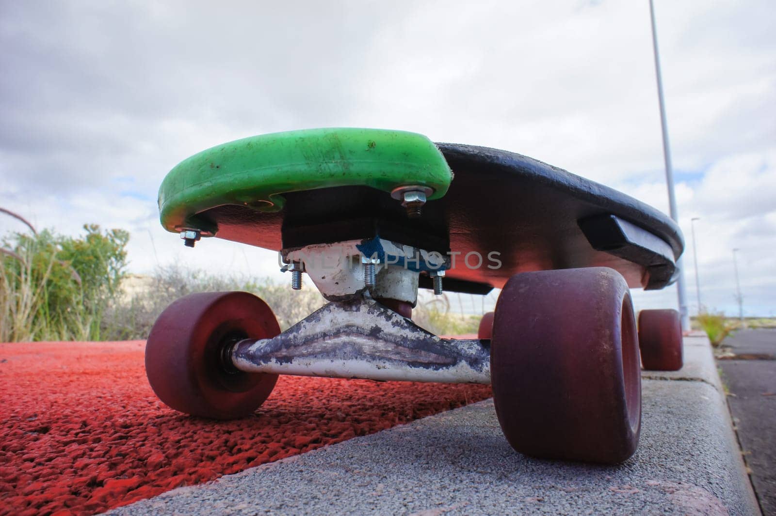 Vintage Style Longboard Black Skateboard on an Empty Asphalt Desert Road