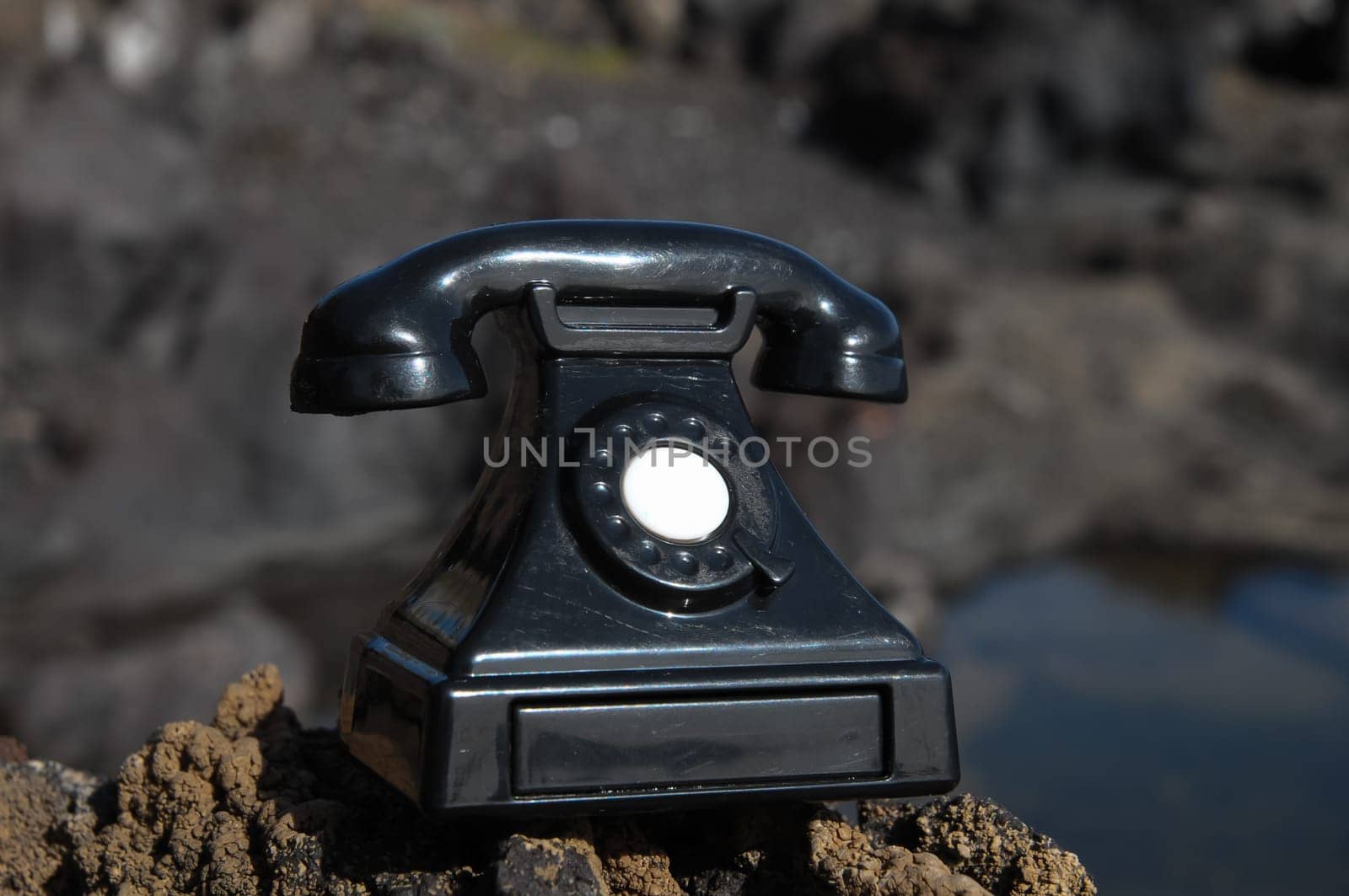 International Communications Vintage Telephone Toy on the Volcanic Rocks