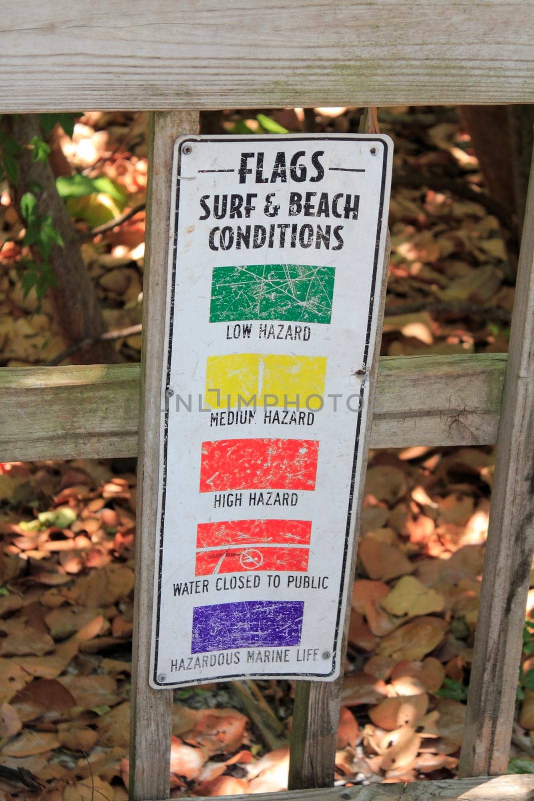 SIESTA KEY, BEACH, FLORIDA - MAY 9, 2013: Five different color flags of public surf, Siesta Beach conditions ranging from low, medium and high hazard, water closed to public to hazardous marine life.