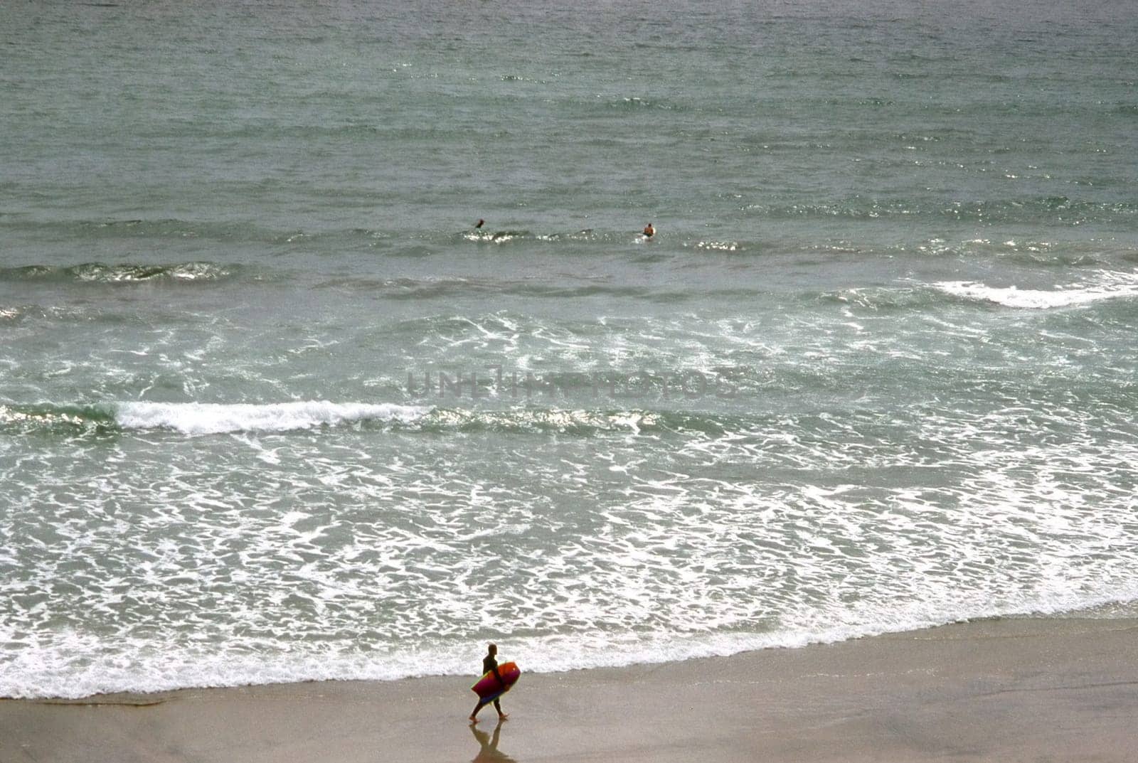 Surfer on beach in San Diego, California
