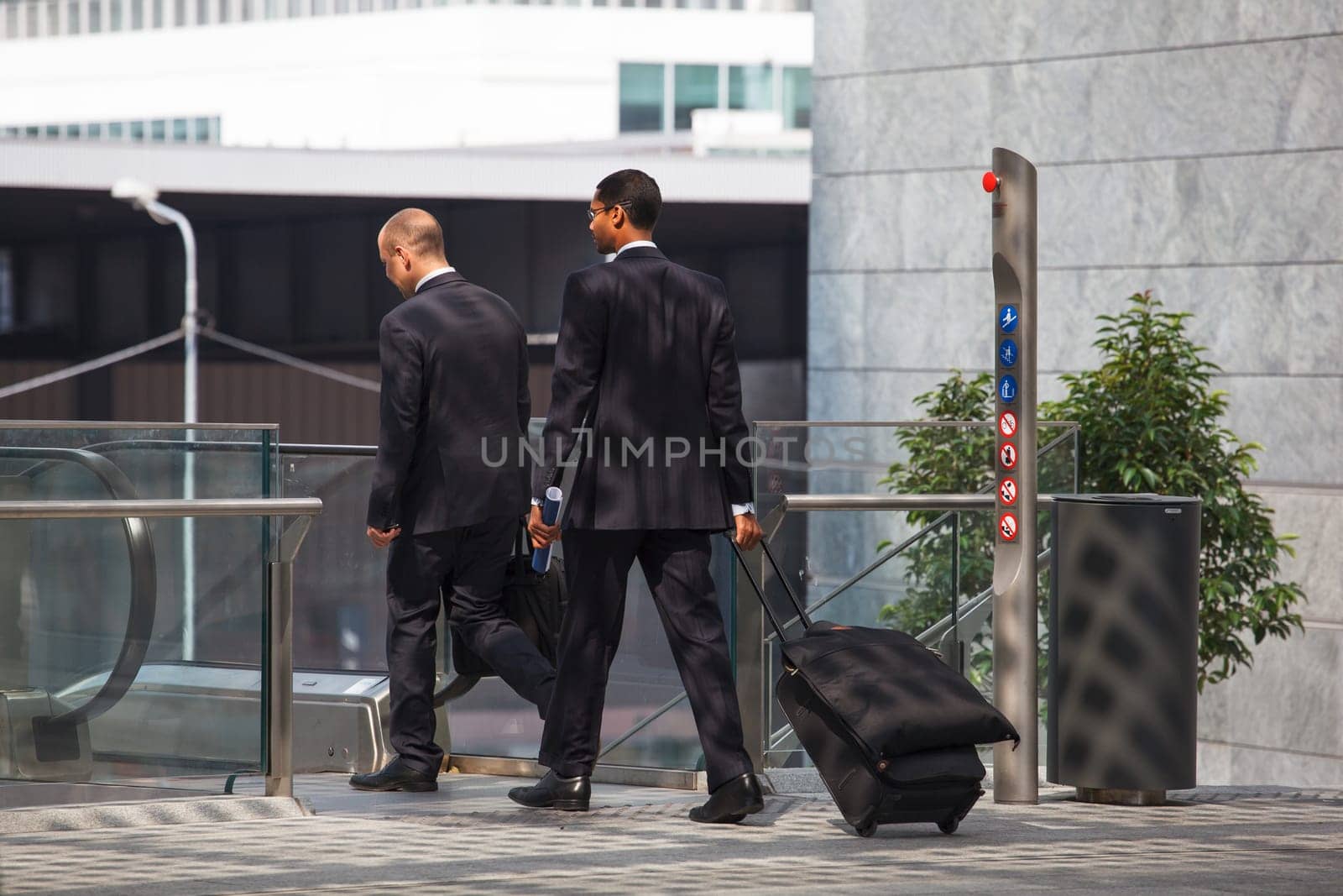 business men walking with travel bag