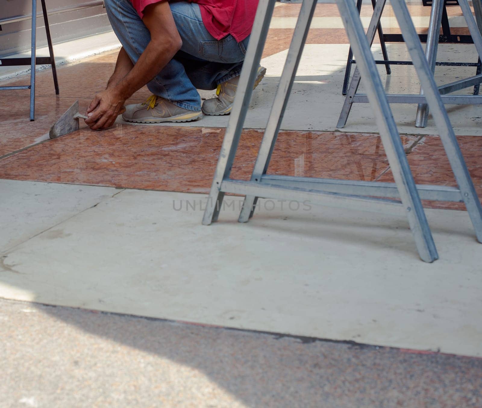 Worker in action with trowel in the floor