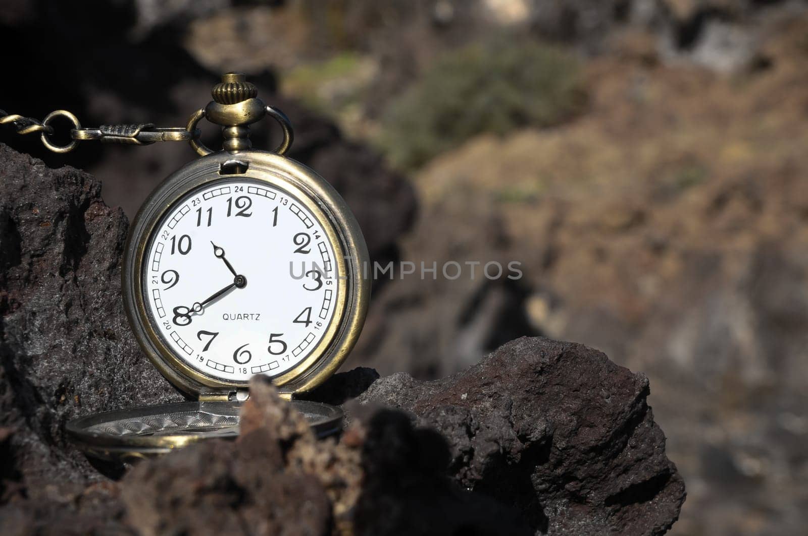 Time Concept Classic Vintage Pocket Clock on the Volcanic Rocks